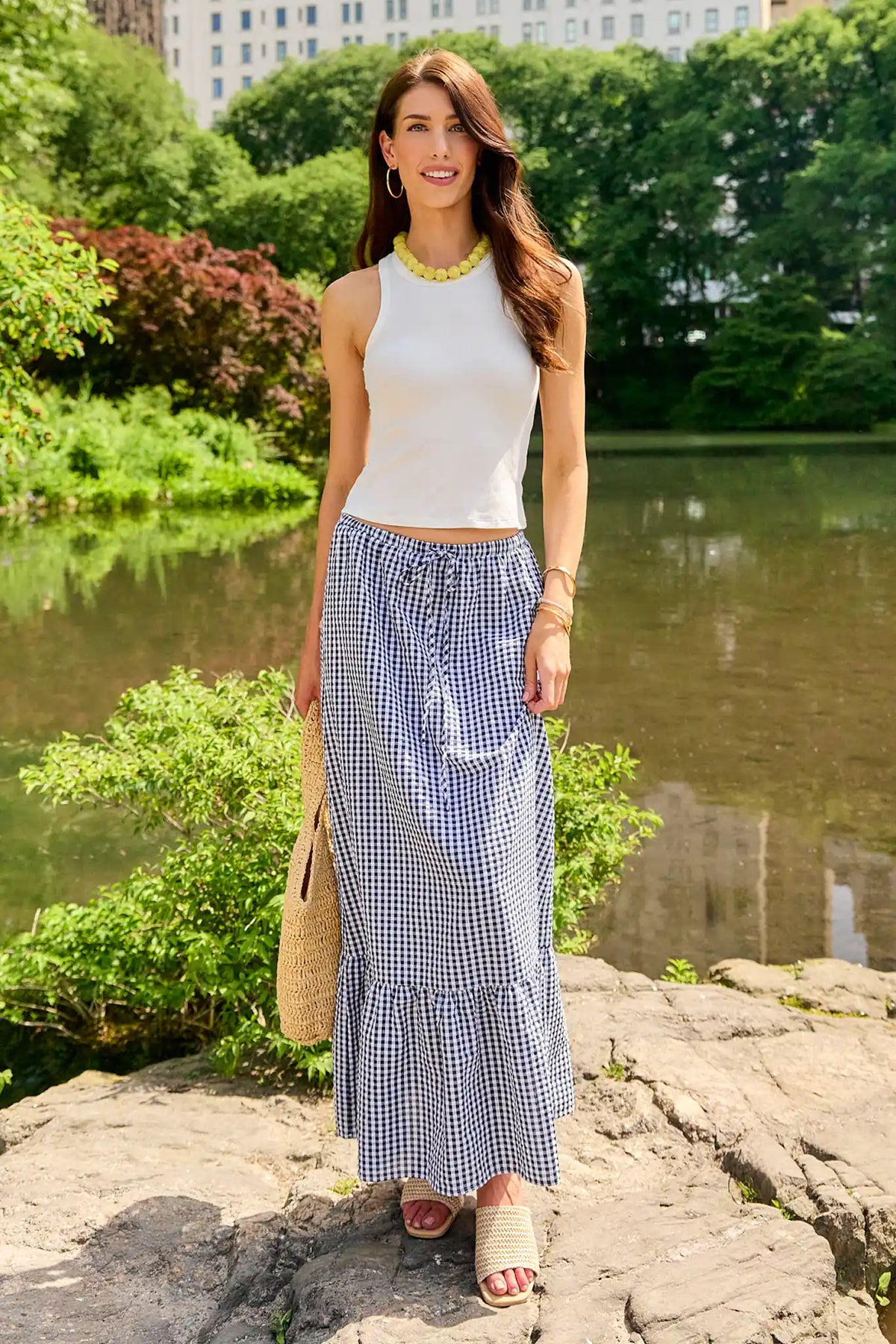 Navy gingham ruffle maxi skirt styled with white tank and straw bag, outdoor lifestyle look | Avara