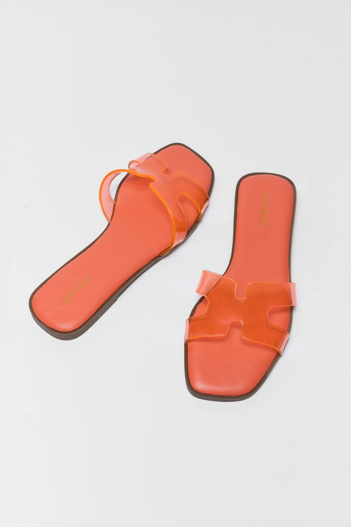 Orange jelly slip-on sandals with clear H-strap and square toe - Angled Pair View | Avara