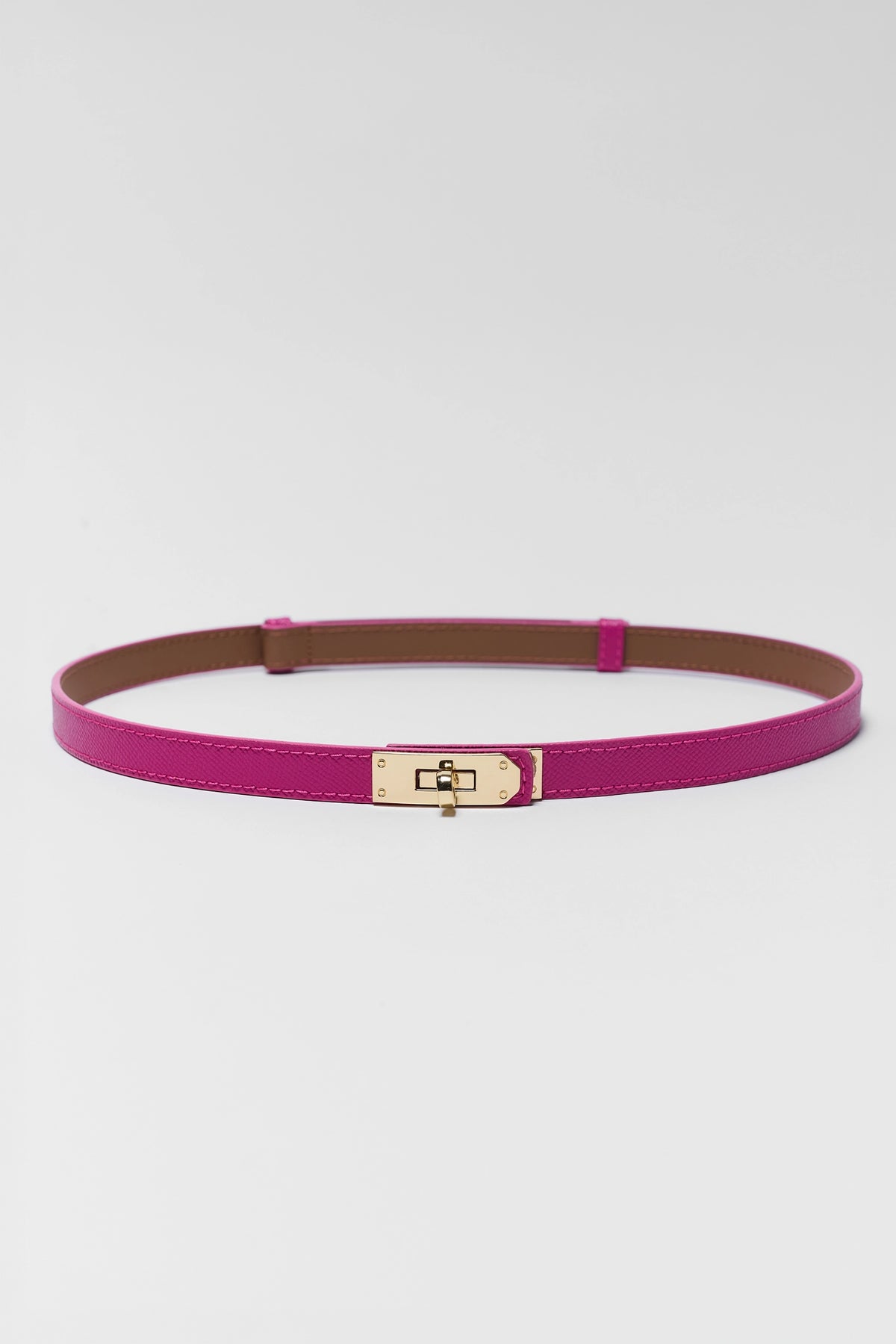 Piper Pink Faux Leather Belt laid flat, slim silhouette with gold turn-lock clasp detail - Front View | Avara