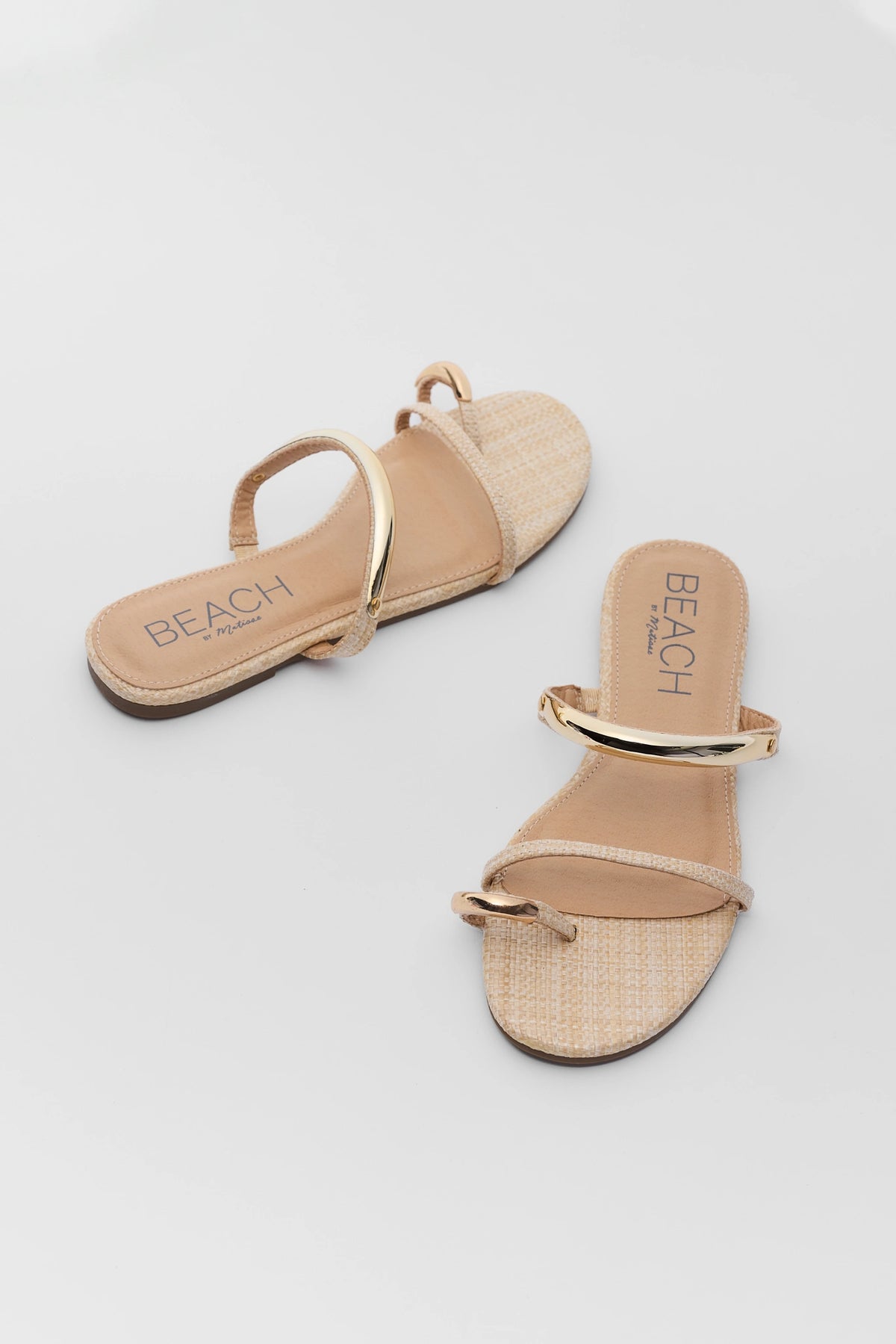 Natural raffia gold detail sandals pair, angled overhead view - gold raffia sandals by Matisse | Avara