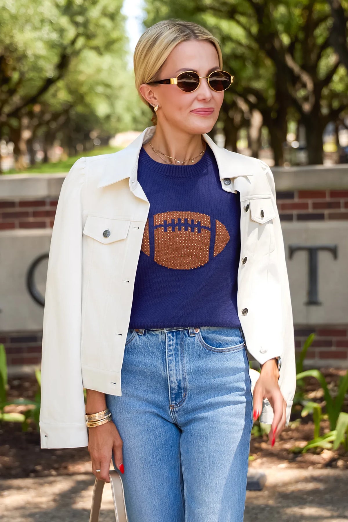 Roxanna Cream Faux Leather Jacket - Game Day Lifestyle Look, layered over navy football sweater with jeans | Avara