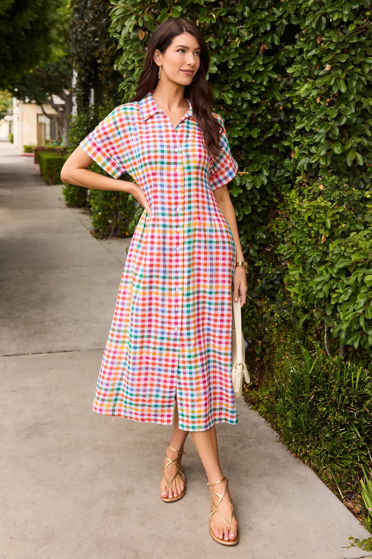 Colorful gingham maxi dress styled outdoors with gold sandals, modest button-front shirtdress | Avara