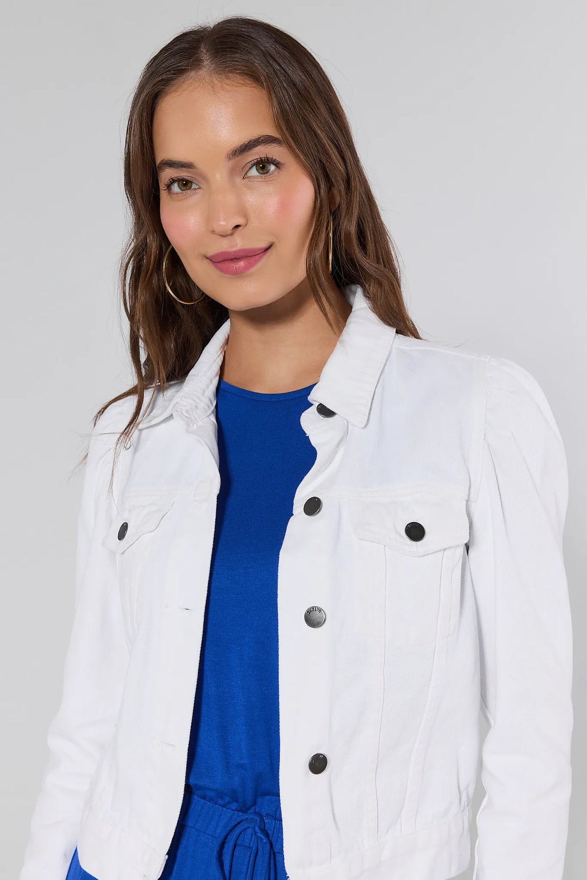 Roxanna White Denim Jacket close-up front detail with button placket over cobalt blue outfit | Avara