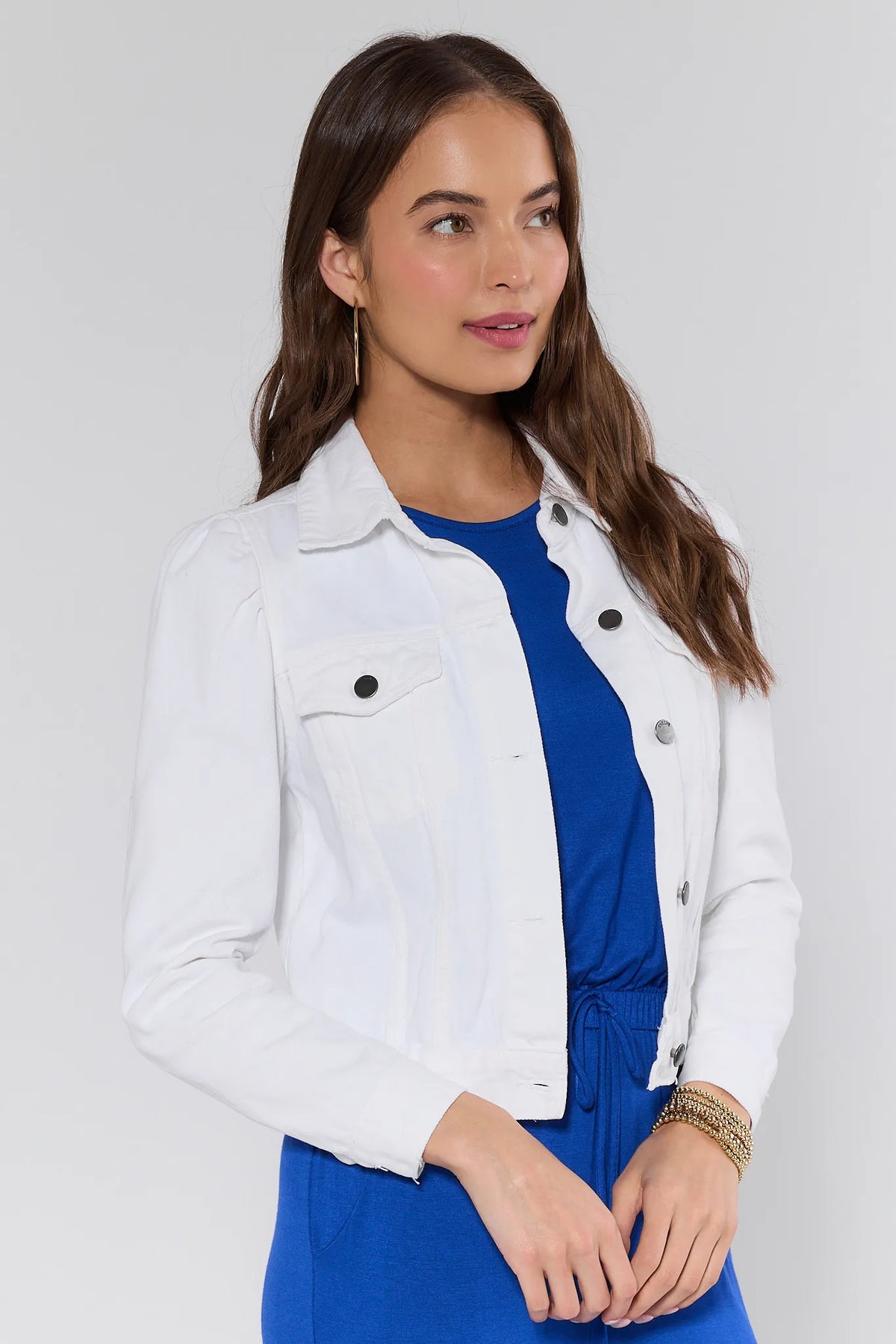 Roxanna White Denim Jacket side angle showing puff sleeve, button detail, and cropped fit over blue outfit | Avara