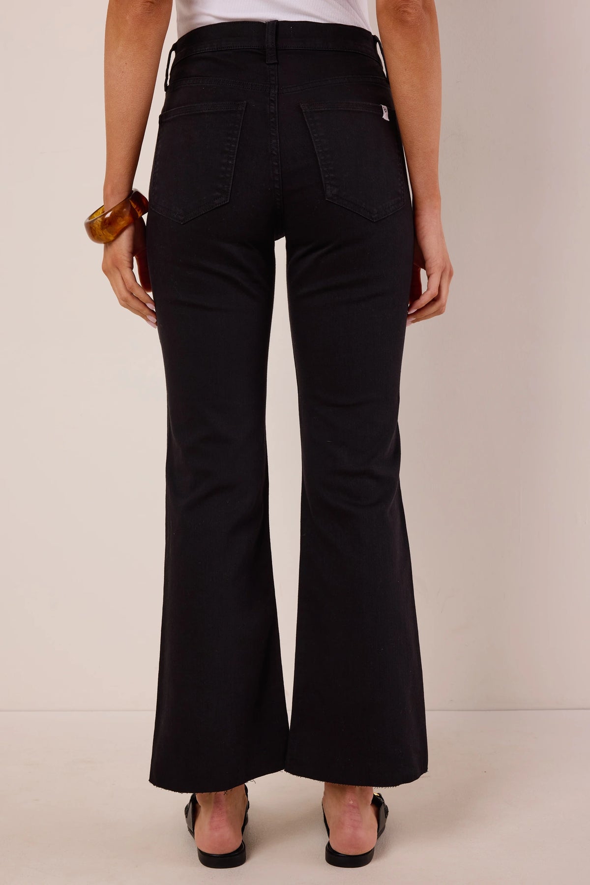 Heather Black Kick Flare Jeans back view showing flare silhouette, back pockets, and raw hem detail | Avara