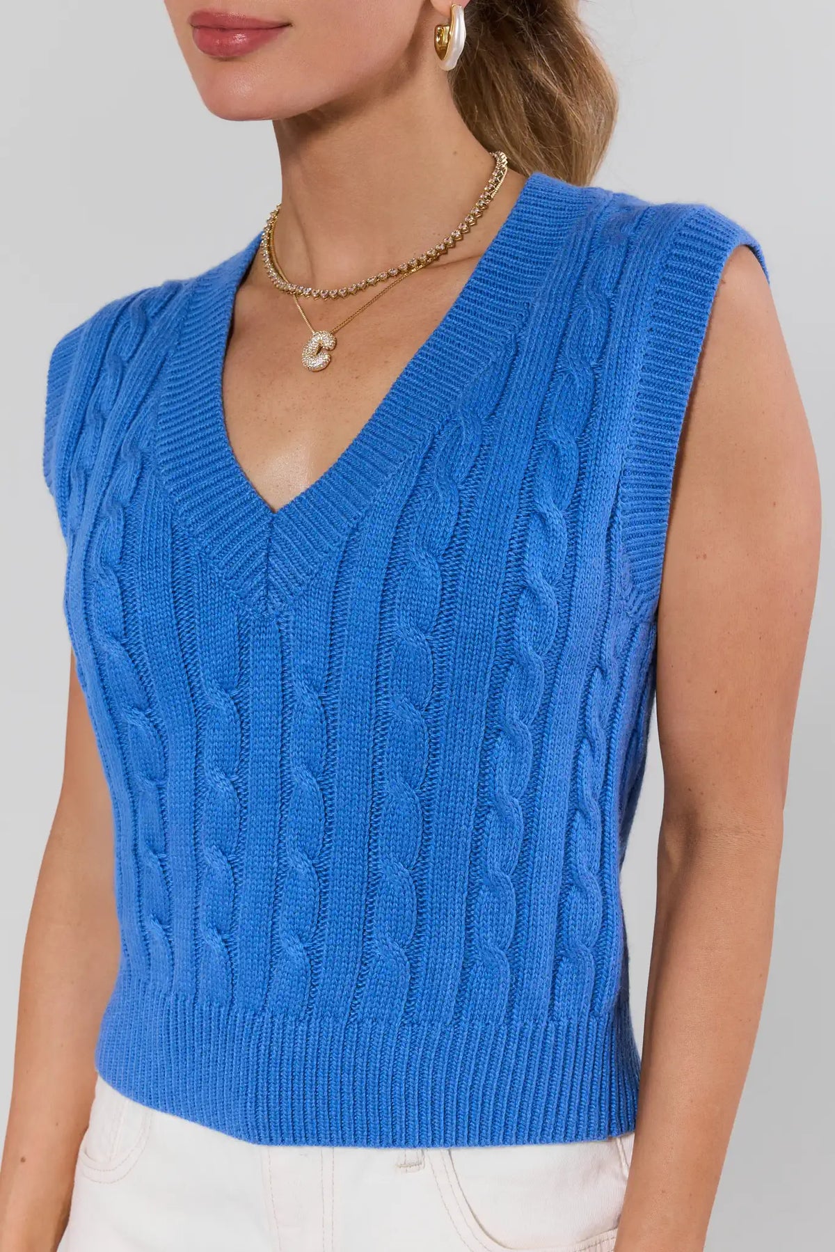 Blue cable knit sweater vest womens close-up, V-neck and texture detail | Avara