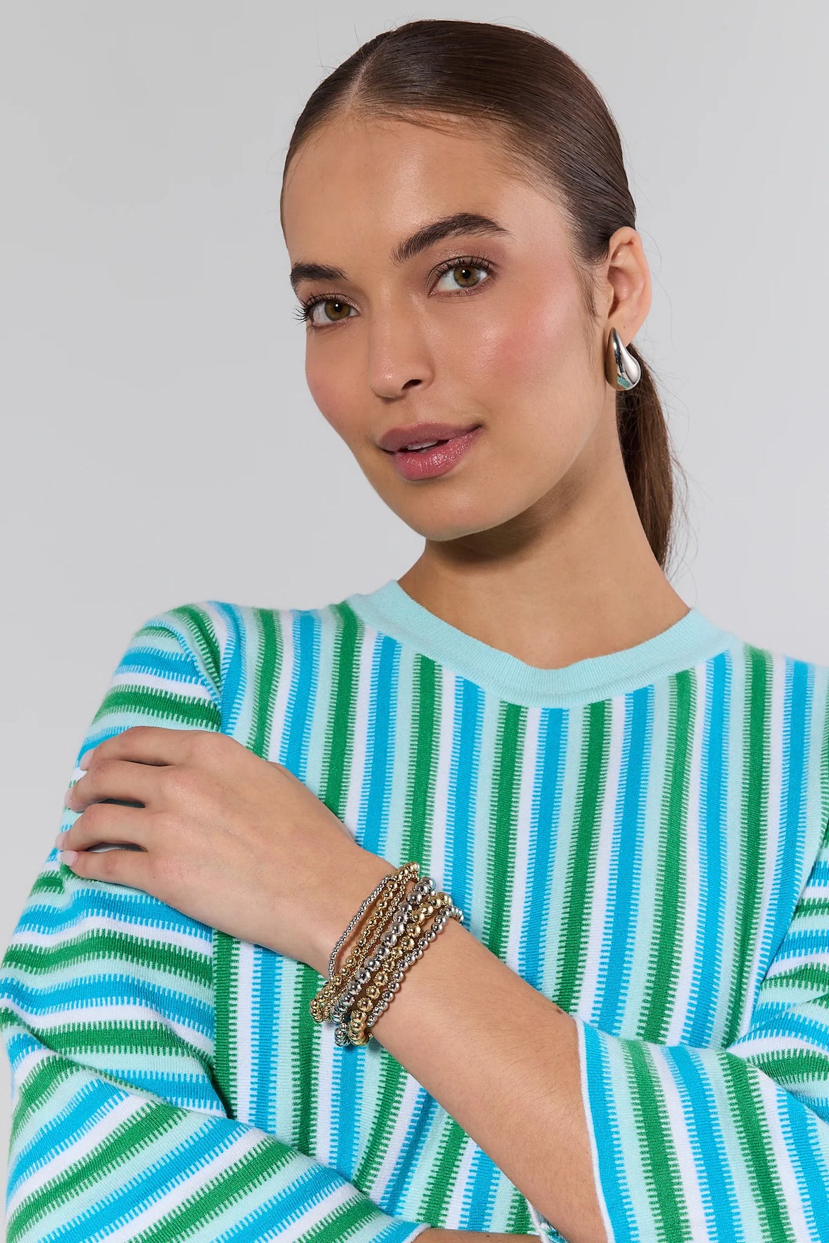 Woman wearing Maisie Two Tone gold and silver beaded bracelet set stacked on wrist - On Model | Avara