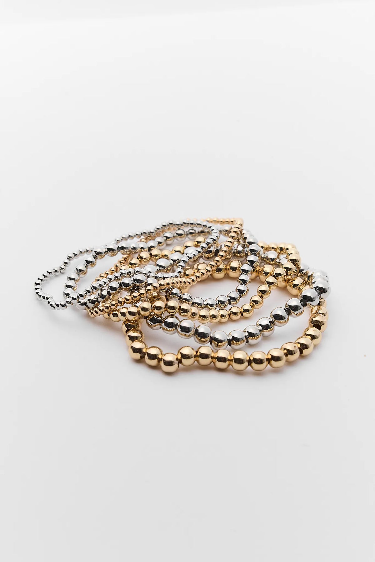 Maisie Two Tone Bracelet Set - gold and silver beaded stack of 6, flat lay | Avara