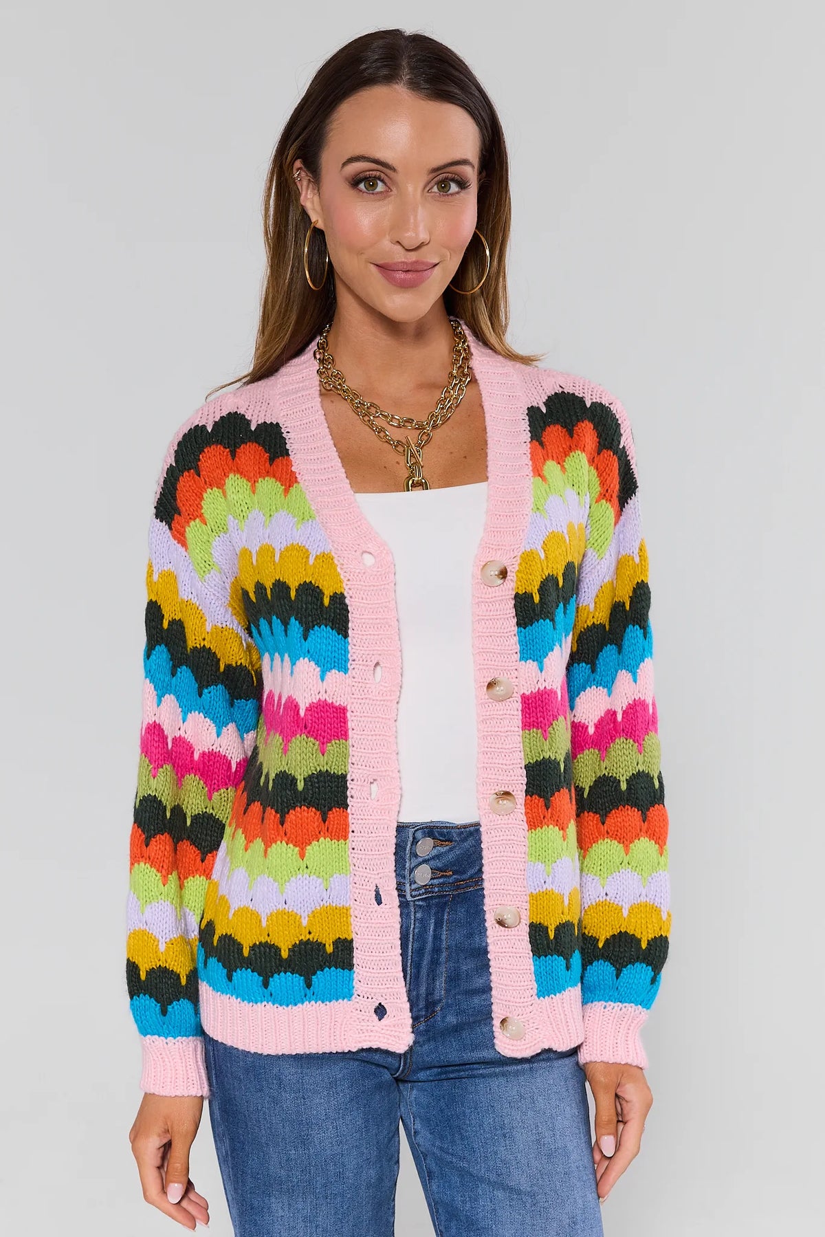 Woman wearing a colorful cardigan with a white background