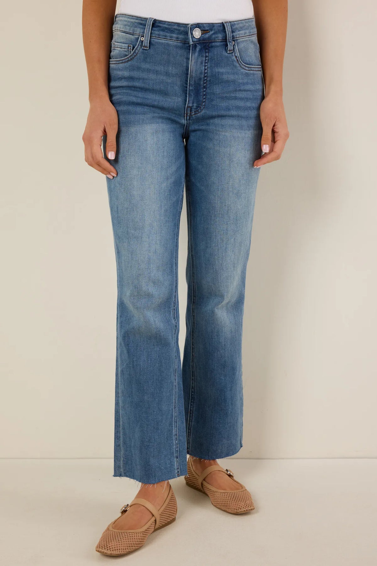 Kelsey Light Wash Kick Flare Jeans by KUT - Front View, high-rise with raw hem, paired with tan flats | Avara