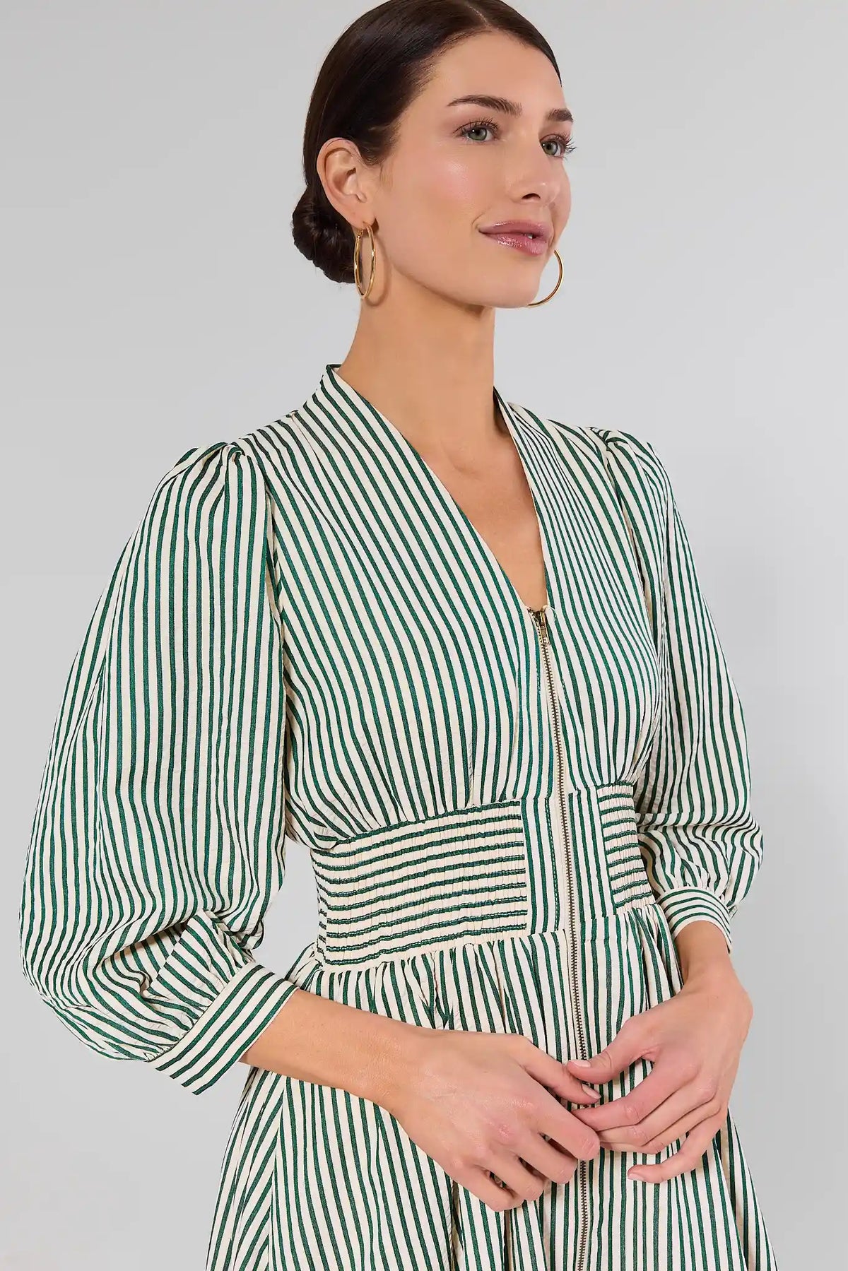 Close-up of green and white striped Brantley Midi Dress showing smocked waist and zip neckline detail | Avara