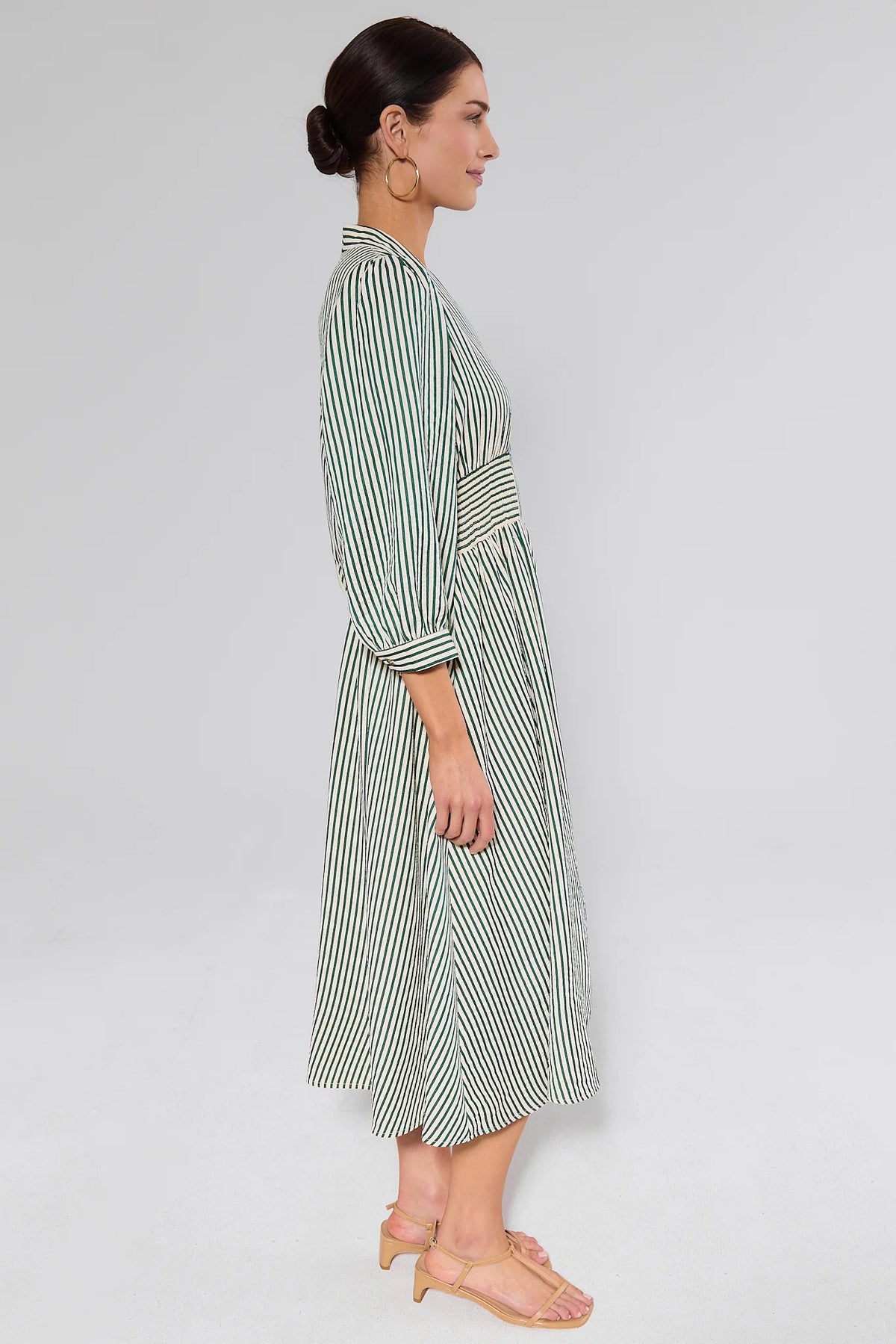 Side profile of green and cream striped Brantley Midi Dress showing modest midi length and relaxed silhouette | Avara