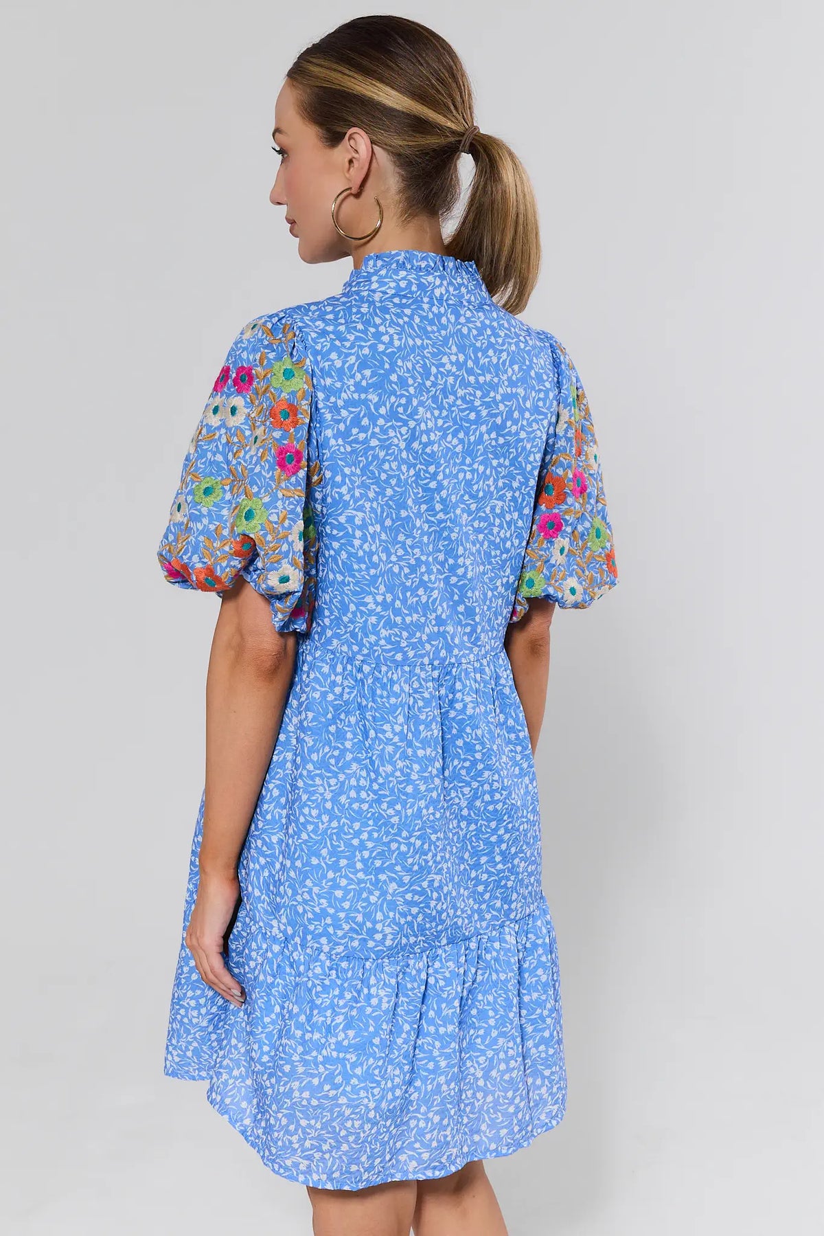 Sue Ann Blue Floral Short Dress by THML - back view showing ditsy floral print, colorful embroidered sleeves, and tiered hem | Avara