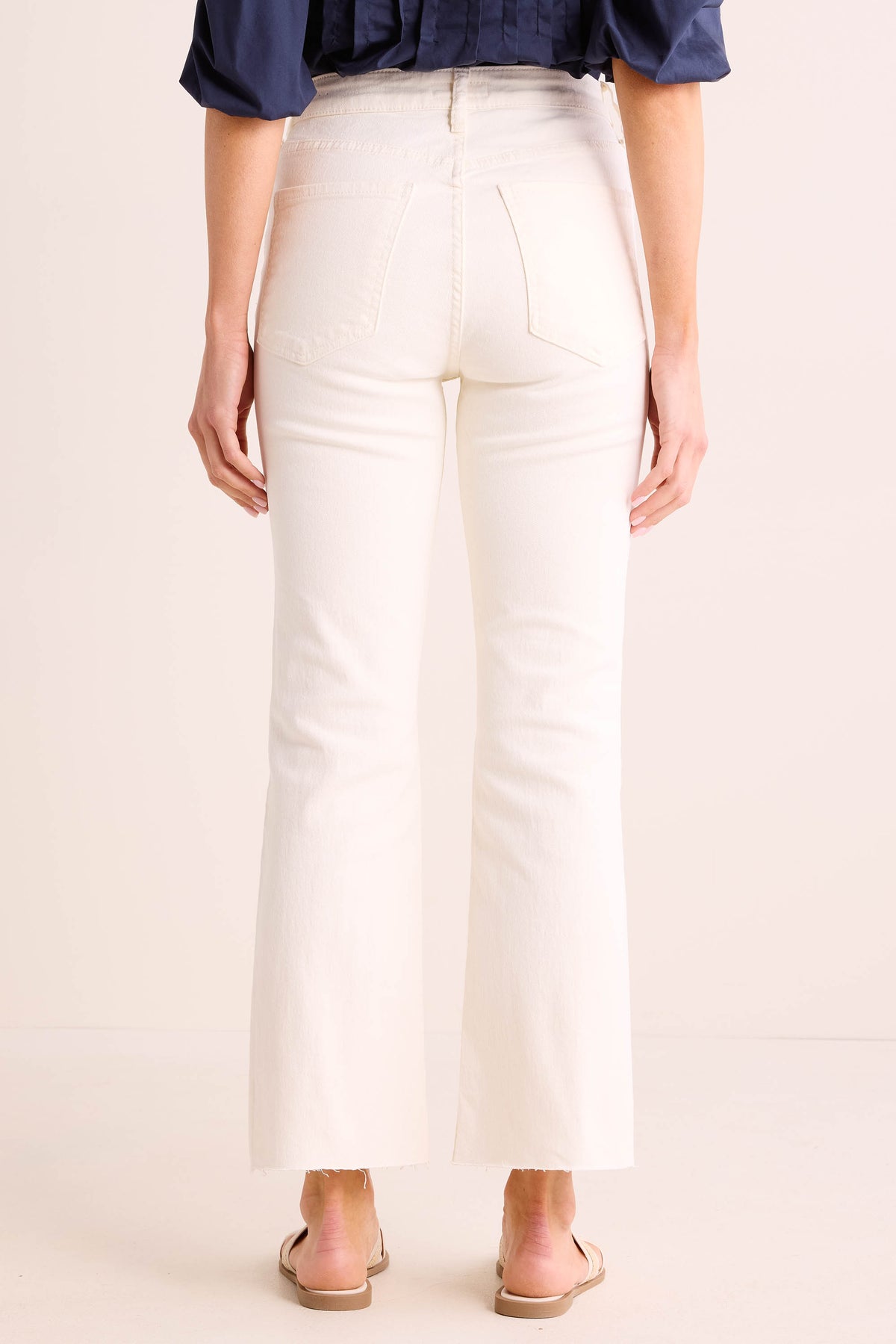 Kelsey Ecru Kick Flare Jeans back view showing high waist, back pockets, and raw-cut flared hem | Avara