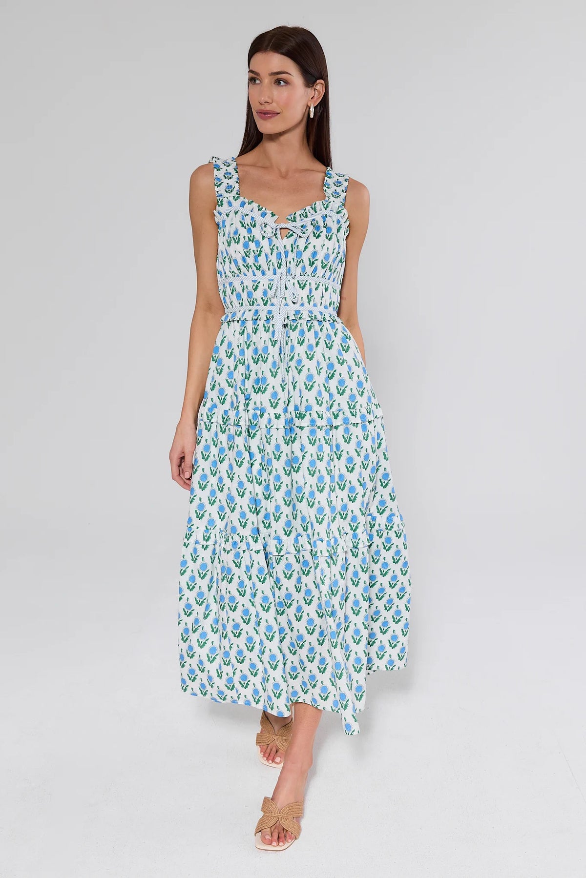 Woman wearing a floral dress on a plain background