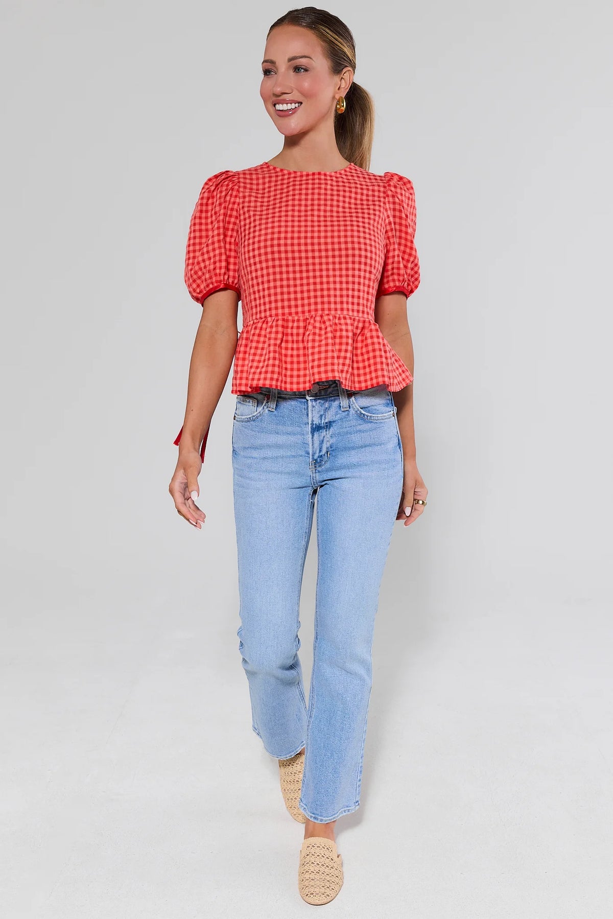 Felicia Red Gingham Peplum Top full-length front view paired with light blue jeans | Avara
