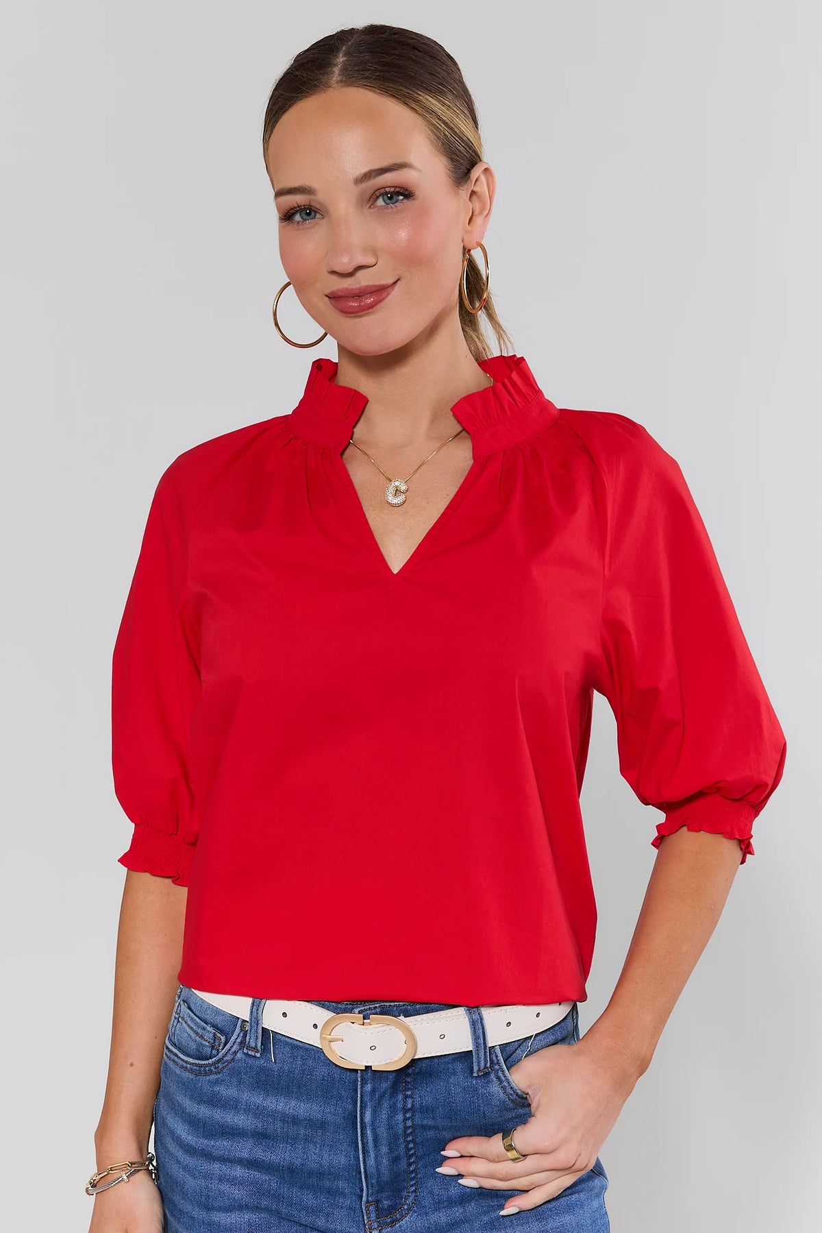 Red Merrick Split Neck Top with ruffle collar and puff sleeves, styled with blue jeans - Front View | Avara