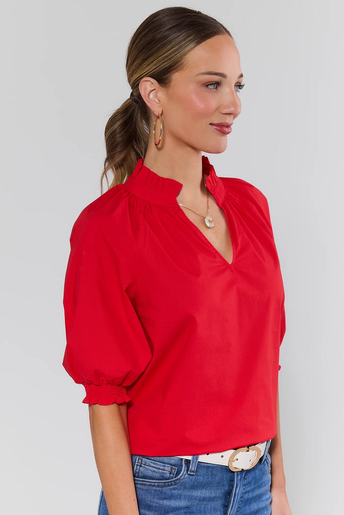 Red Merrick Split Neck Top showing ruffle neckline and puff sleeves - Side Profile View | Avara