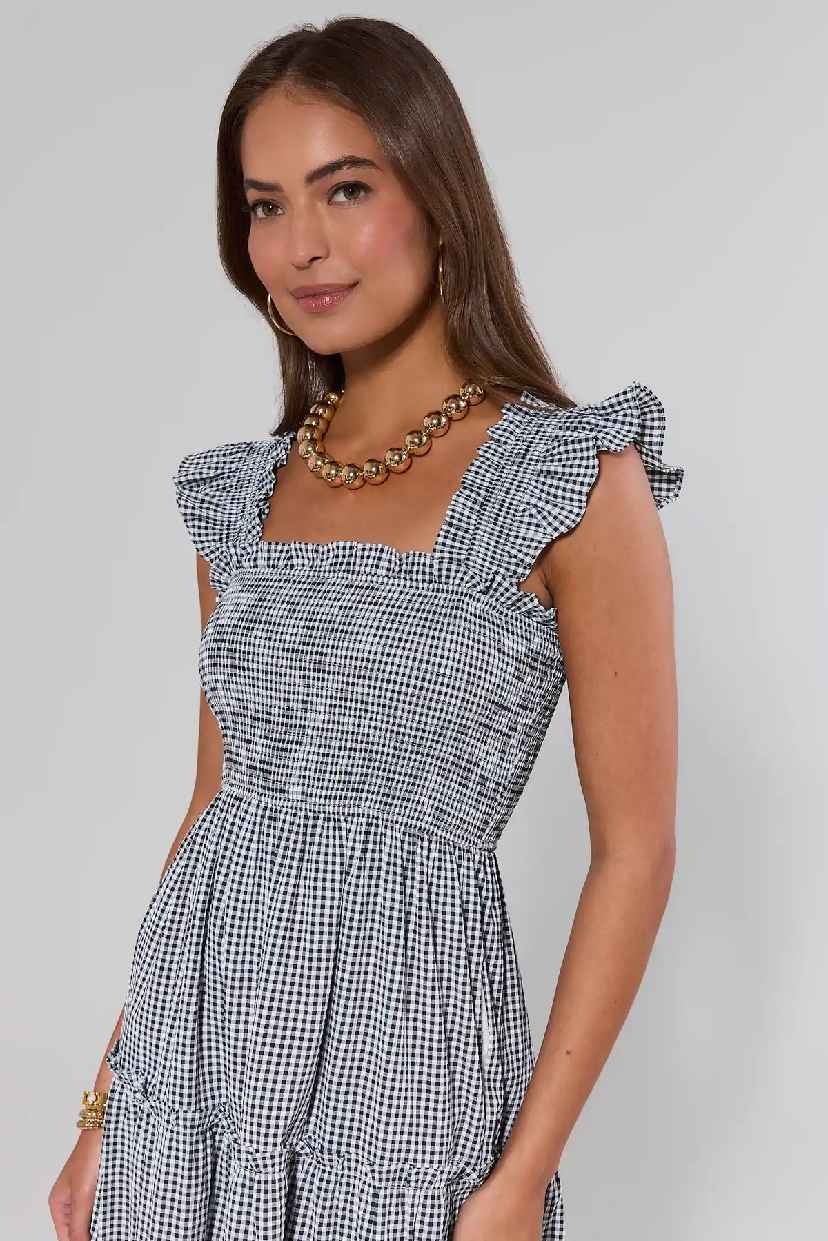 Black and white gingham midi dress close-up showing smocked bodice and ruffle straps - Detail View | Avara