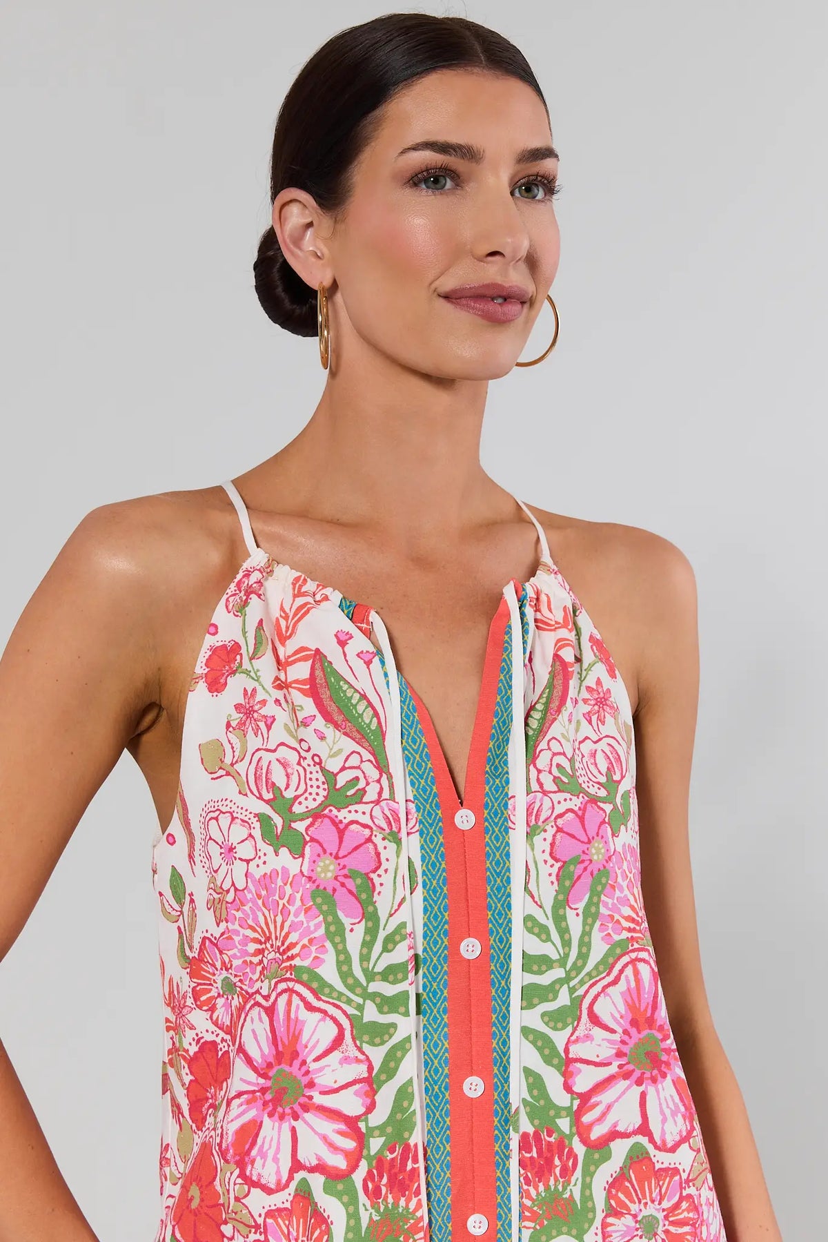 close up Woman wearing a floral dress with a gray background