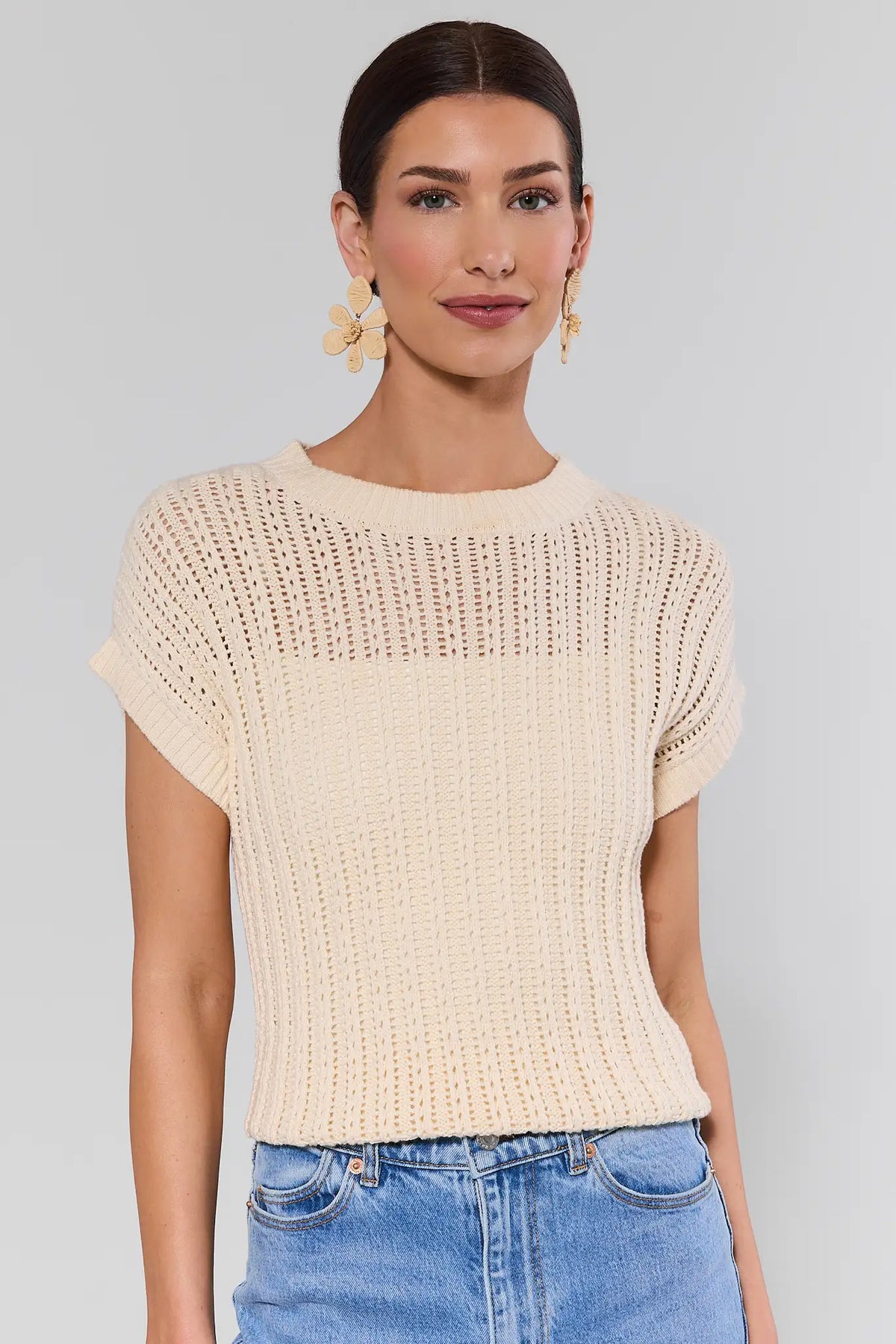 Cream crochet knit Beatrice Top - Front View, styled with blue jeans and gold flower earrings | Avara
