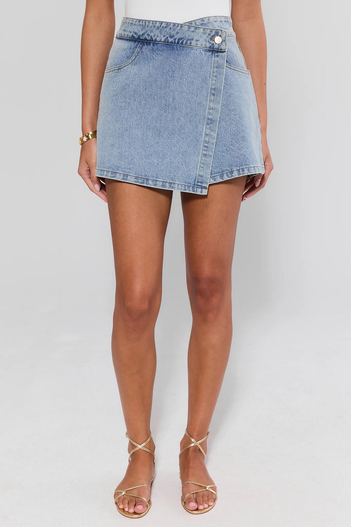 Light Blue Women's Denim Wrap Skort - Front View, Full Length On Model with Gold Sandals | Avara