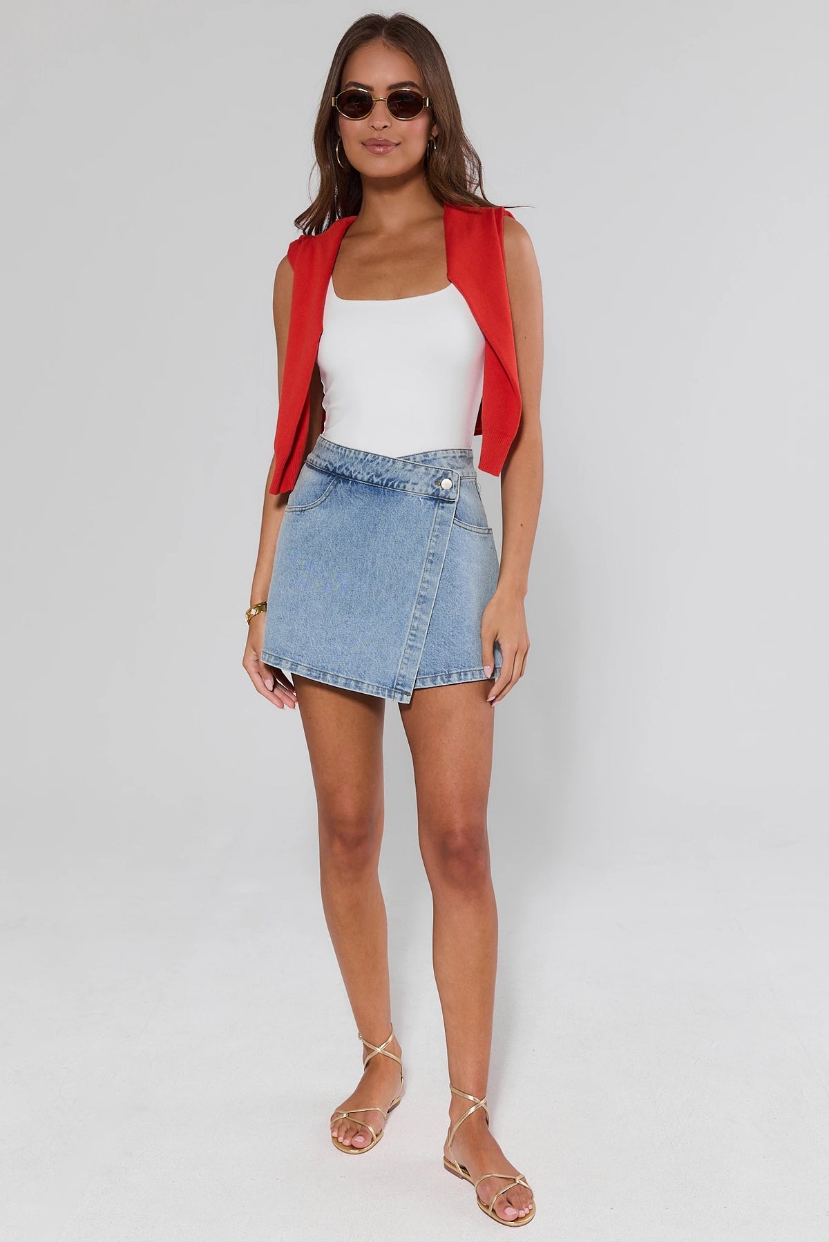 Nikki Denim Wrap Skort Styled with Red Vest & White Top - Full Outfit Front View On Model | Avara