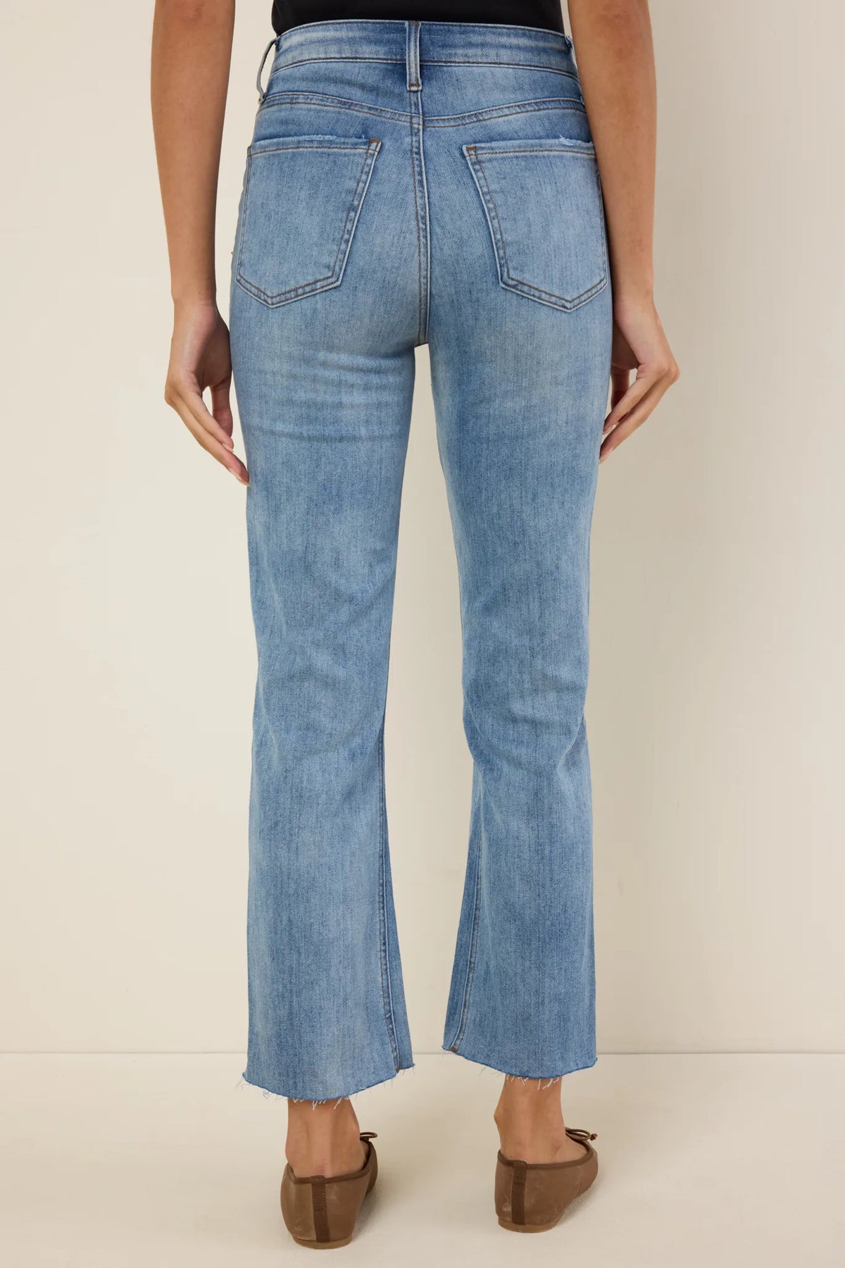 Kelsey Medium Wash Kick Flare Jeans - Back View, five-pocket high-rise denim with raw frayed hem | Avara