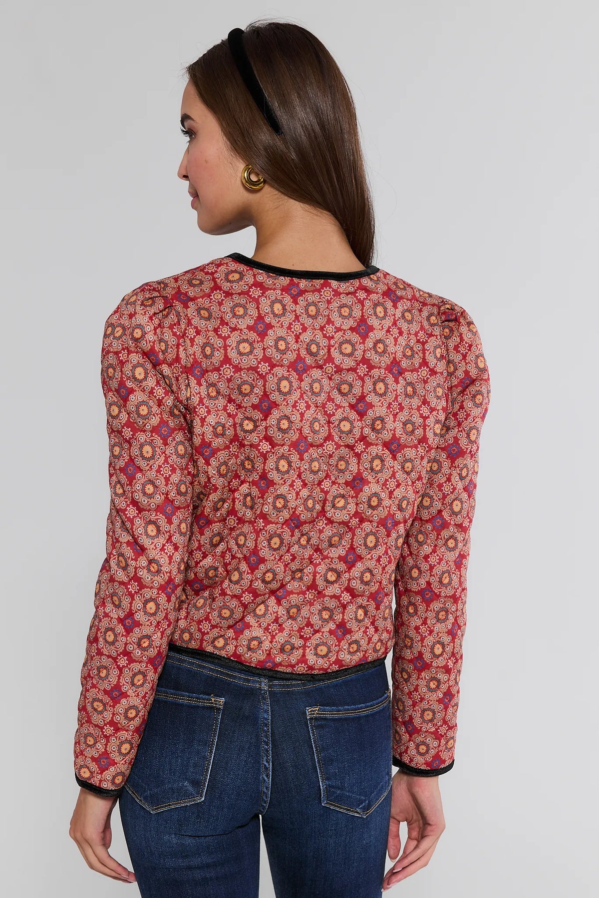 Ember Printed Bow Jacket red floral quilted outerwear, back view showing puff shoulders and black velvet trim, styled with denim jeans | Avara