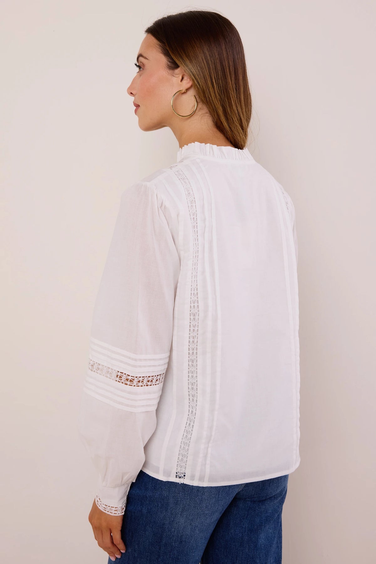 Sable White Button Up Top with lace-inset pintucks, ruffled collar, and smocked cuffs - Back View, styled with blue jeans | Avara