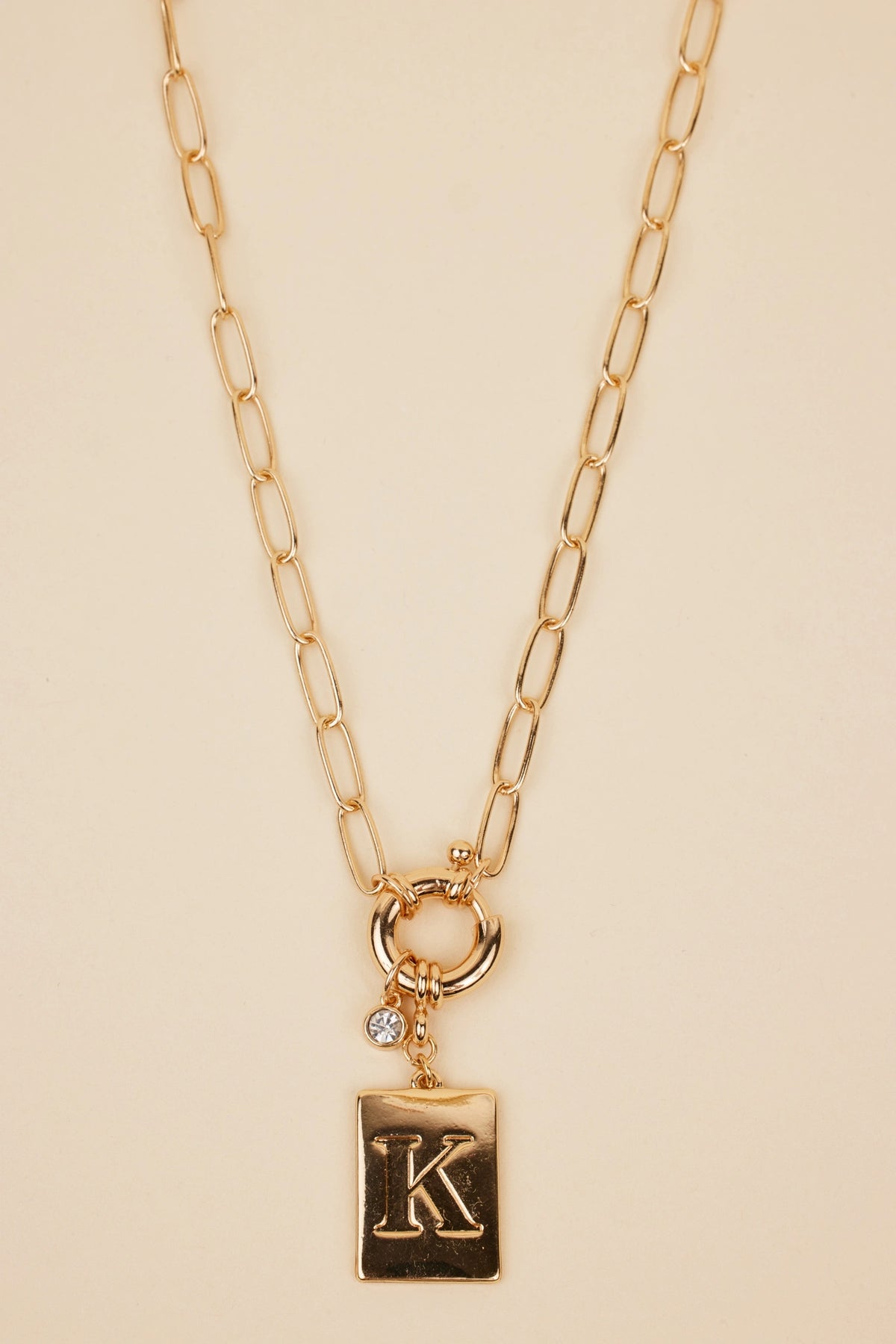 Gold Initial Charm Necklace with paper-clip chain, spring ring clasp, rhinestone accent, and K letter pendant - Close-Up | Avara