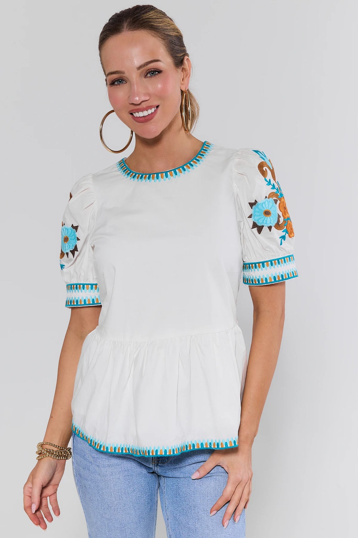White Floral Embroidered Peplum Top, Front View, Styled with Jeans | Avara
