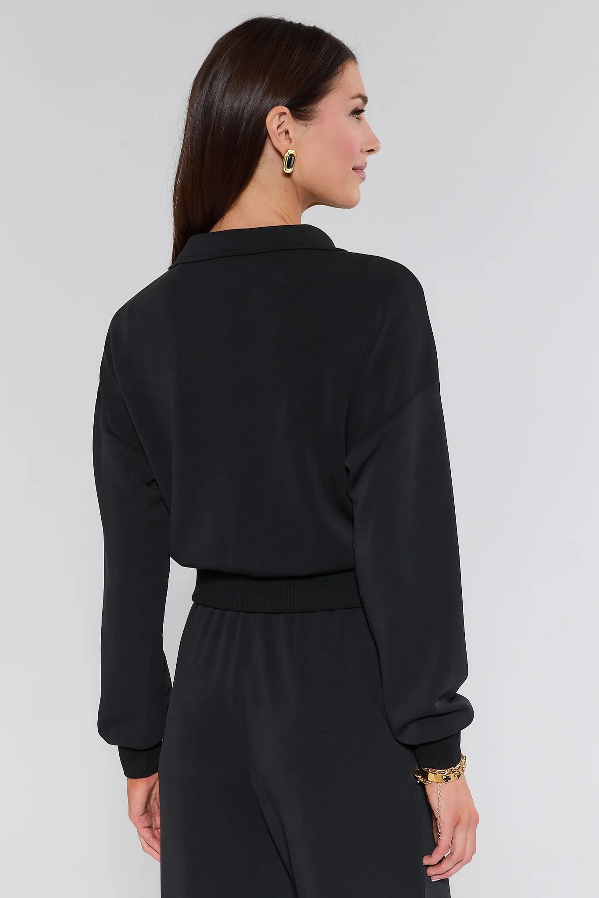 Lucy Black Half Zip Pullover back view showing relaxed fit, spread collar, ribbed hem, with matching pants | Avara