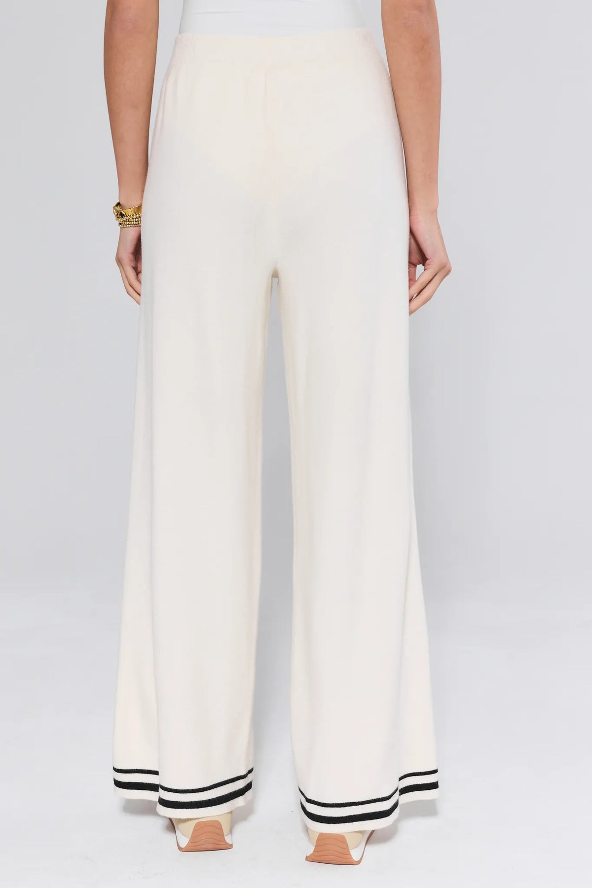 Lexie Ivory Knit Pants back view showing wide-leg silhouette, clean elastic waist, and black stripe hem trim - Back View | Avara