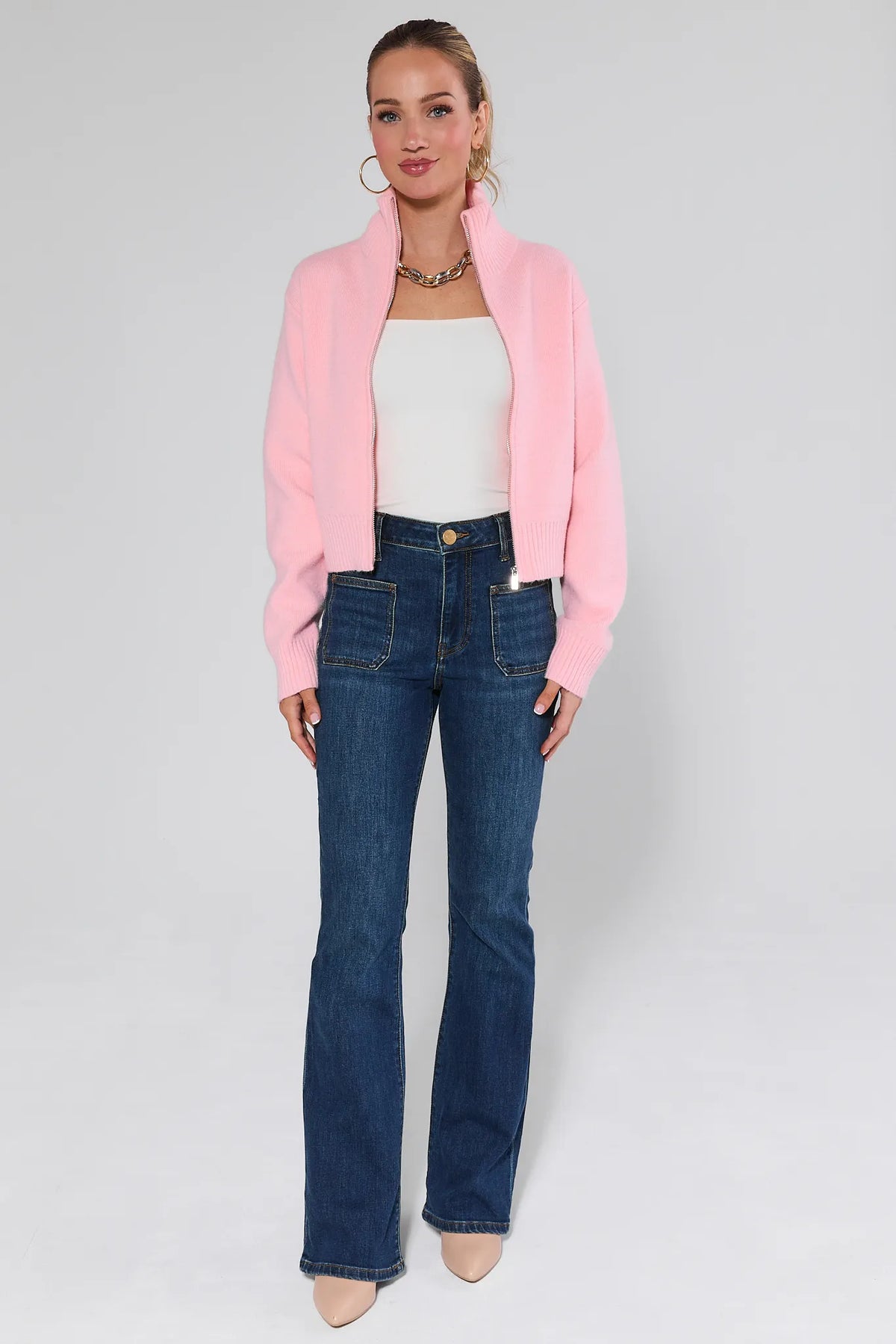 Woman styled in Ana dark wash flare jeans with pink zip sweater - Full Look | Avara