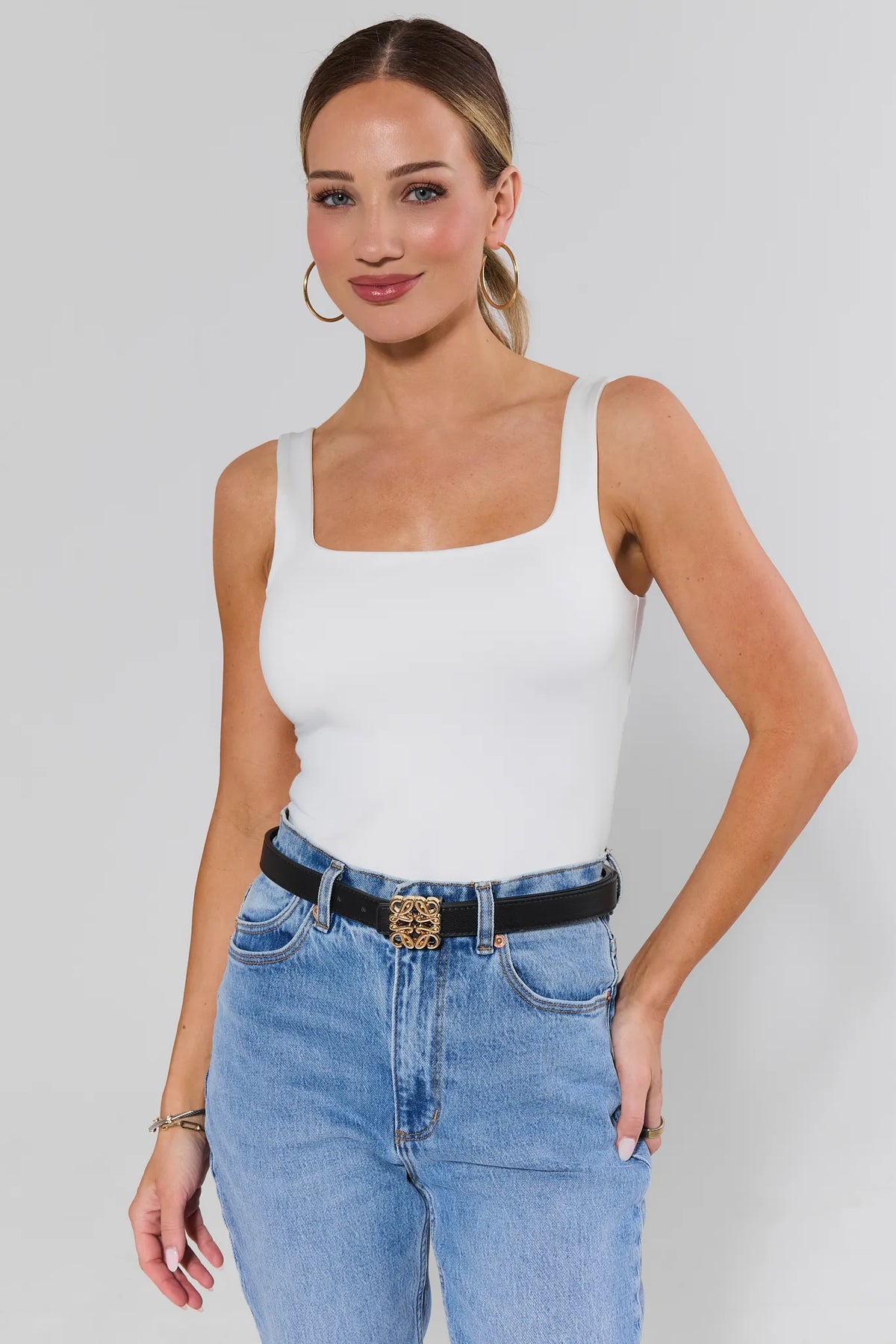 Woman styling Rowan Black Faux Leather Belt with white tank and light wash jeans - On Model | Avara