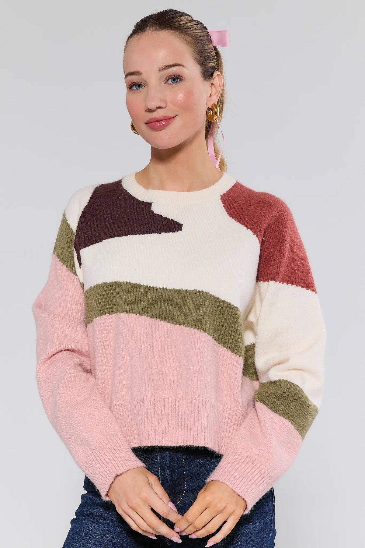 Woman wearing pink, cream, olive & burgundy abstract knit Beverly Sweater - Front View | Avara