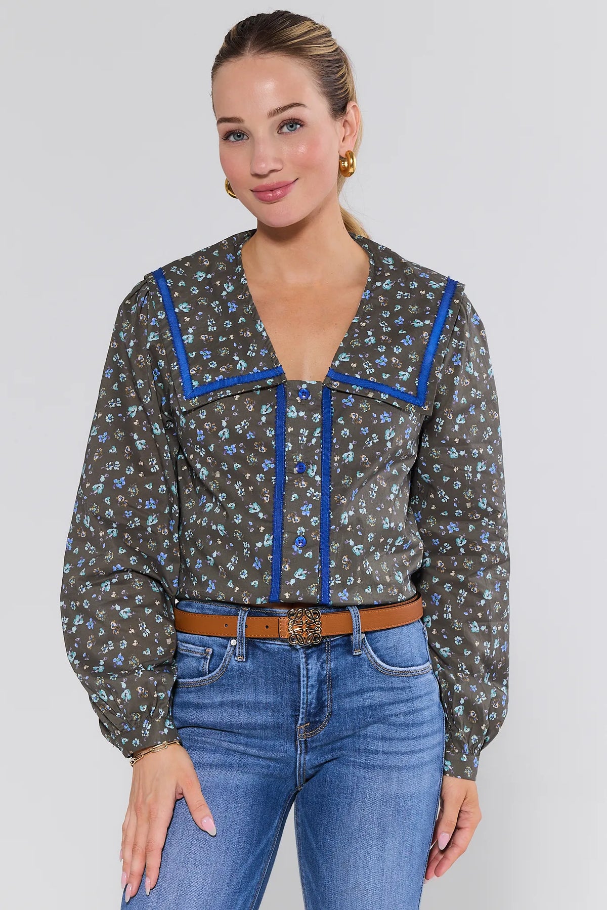 Olive Floral Carol Button Up Top with blue contrast trim collar, on model front view styled with jeans | Avara