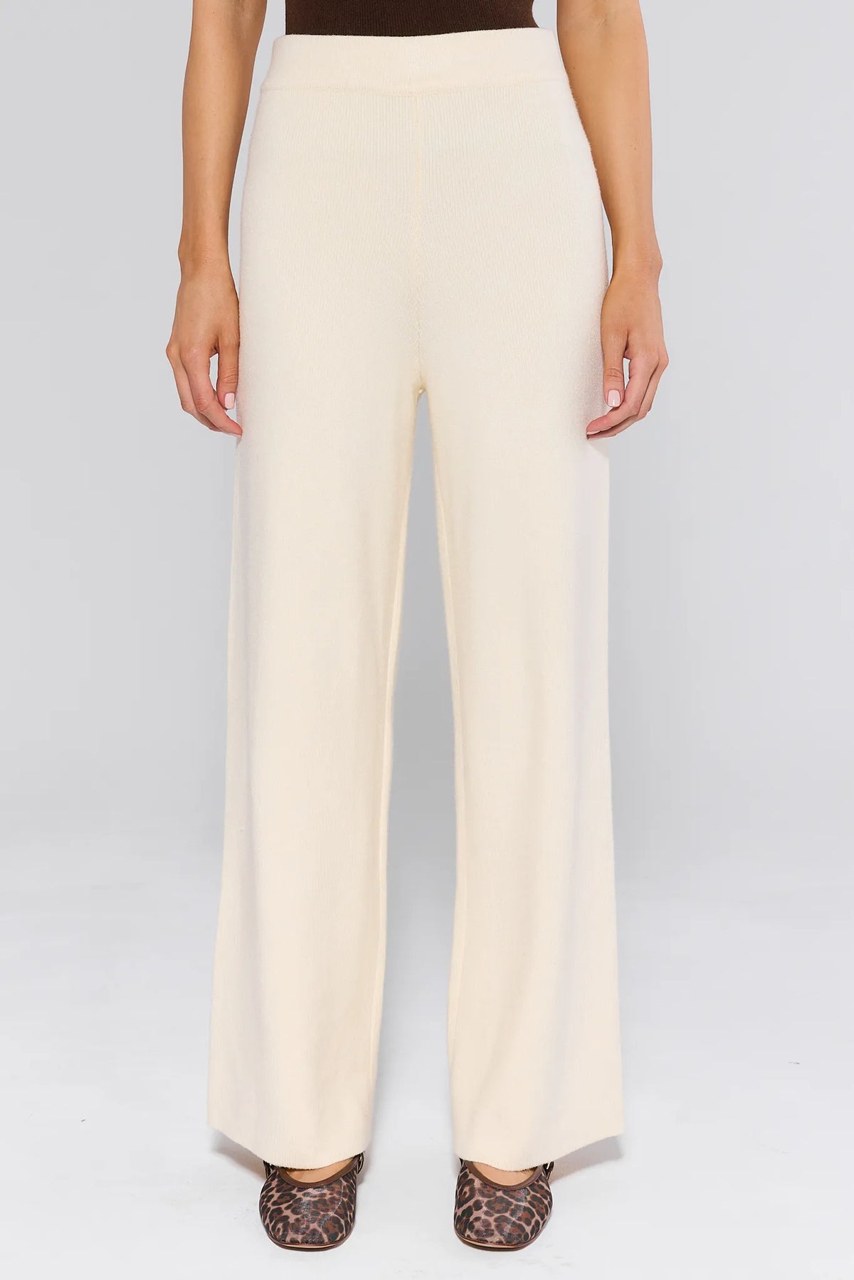 Elle Ivory Knit Pants with high-rise wide-leg silhouette, ribbed banded waist, paired with leopard flats — Front View | Avara