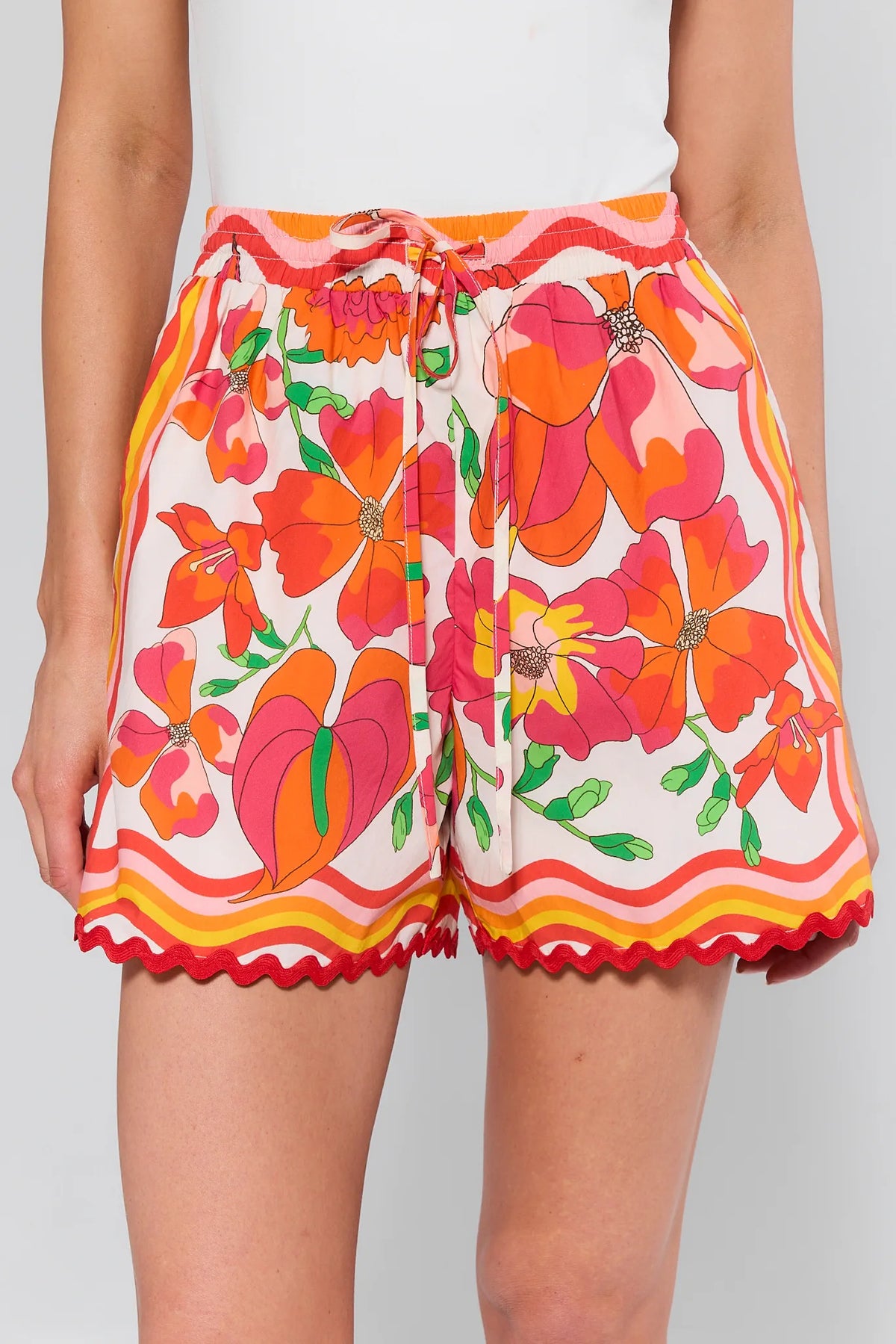 Melissa Orange Printed Drawstring Shorts feature a colorful floral print, scalloped hem, elastic waistband, and drawstring tie, ideal for relaxed, stylish outings.