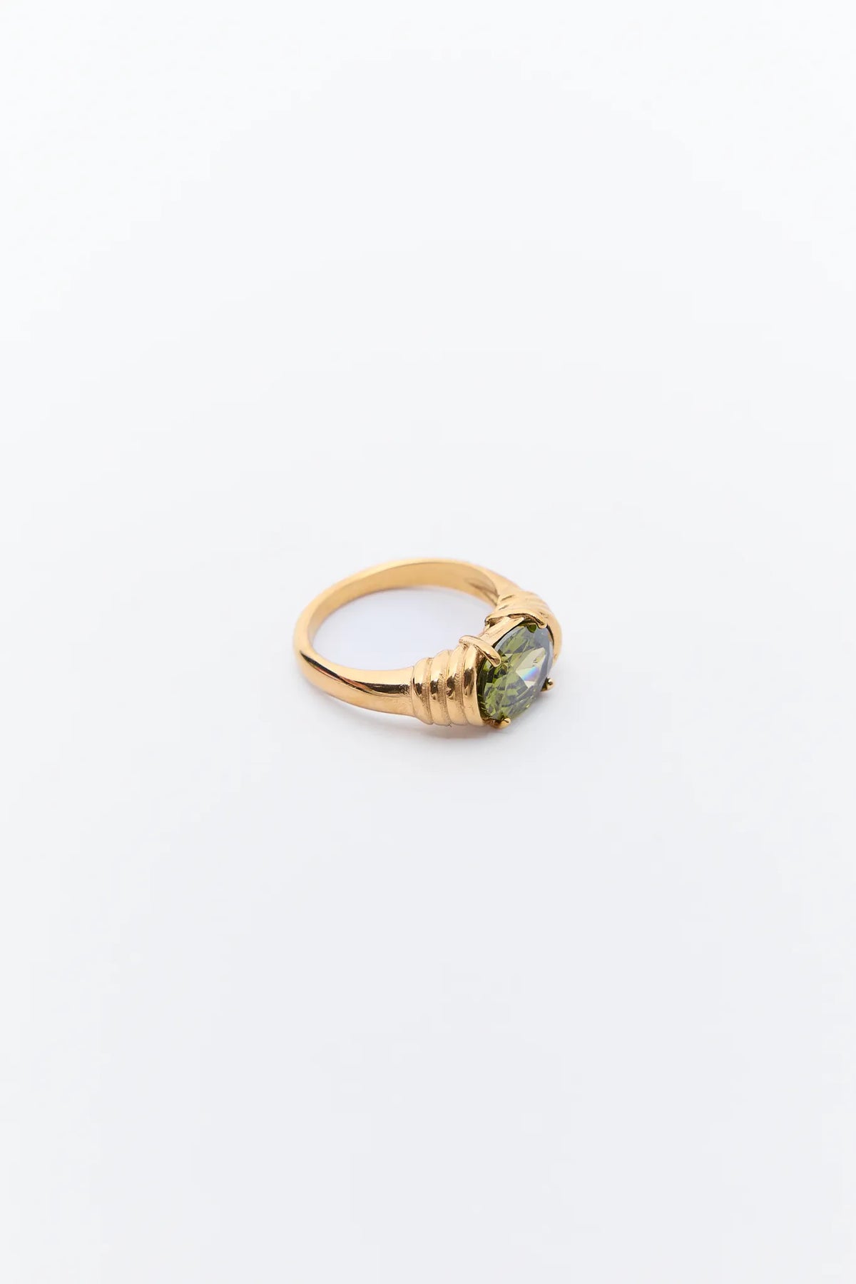 Verna Green Stone Ring featuring a faceted green gemstone in a prong setting on an 18k gold-plated band with abstract wrapped detailing.