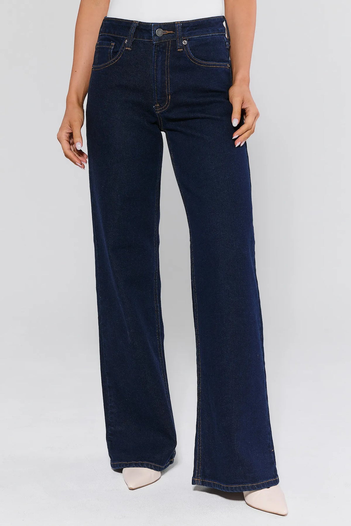 Person wearing dark blue jeans on a white background