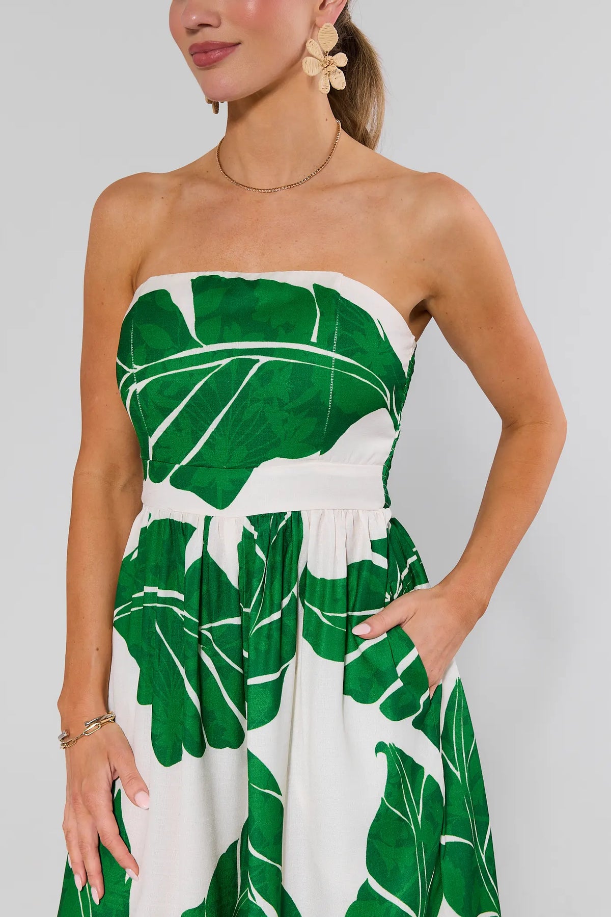 Green palm leaf strapless jumpsuit bodice and waist close-up with pockets - Detail View | Avara