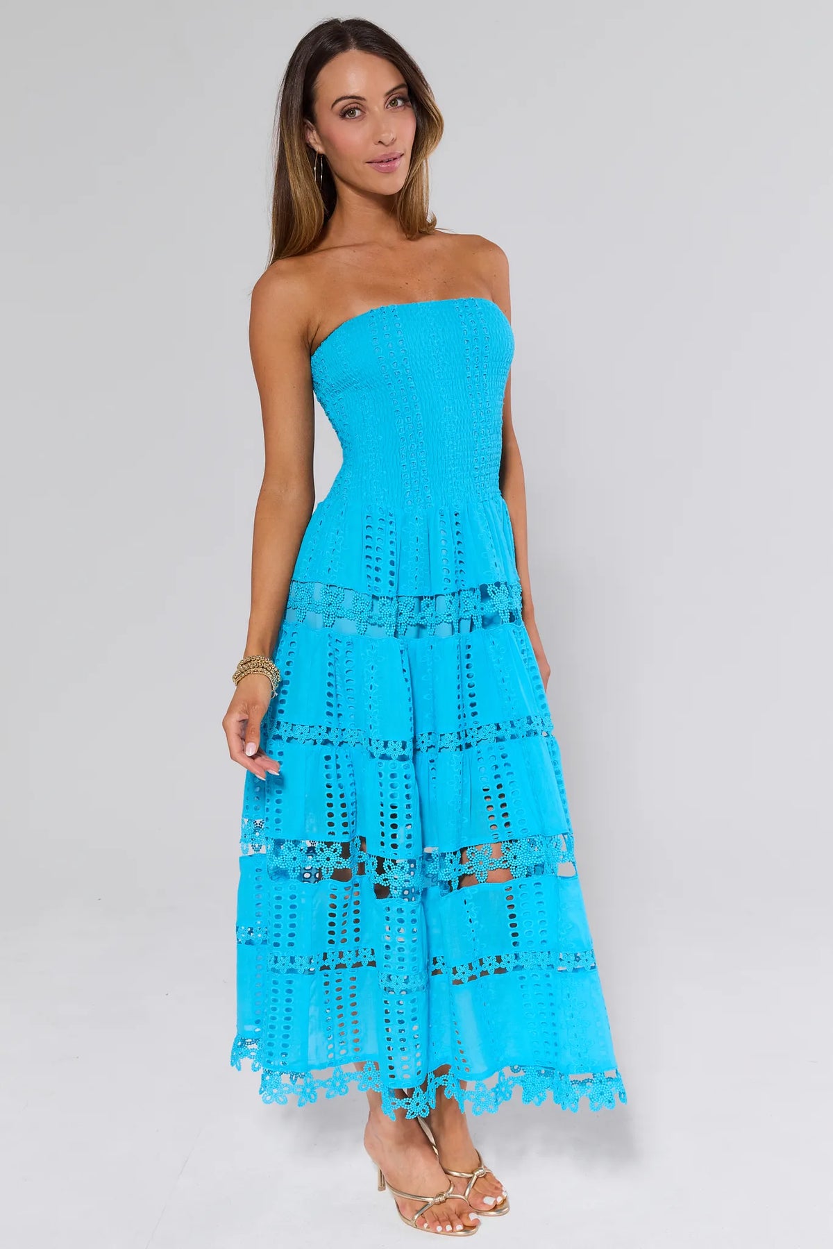 Woman wearing Cecilia Blue Strapless Midi Dress with eyelet embroidery, tiered skirt - Front Angle | Avara