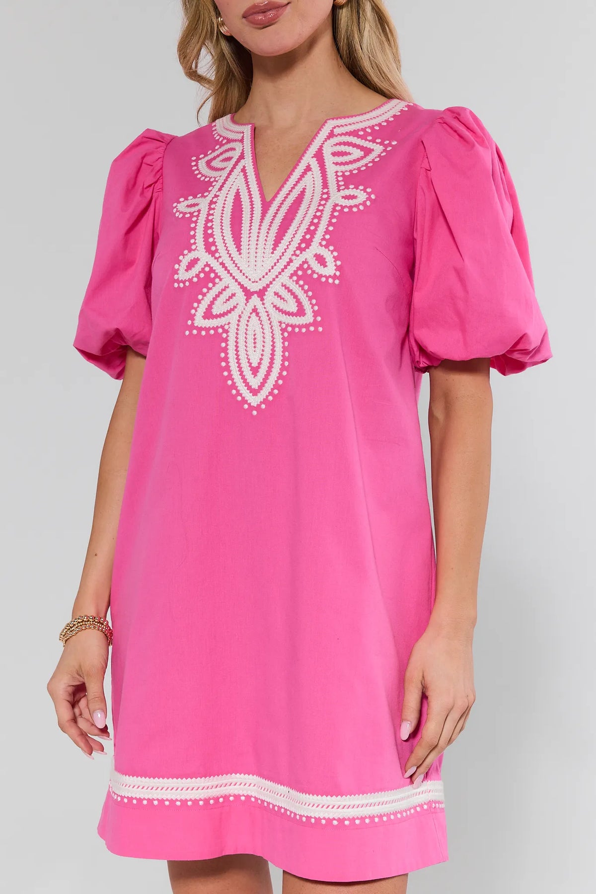 Pink dress with white embroidery, puff sleeves, and A-line silhouette - Close-Up Detail | Avara