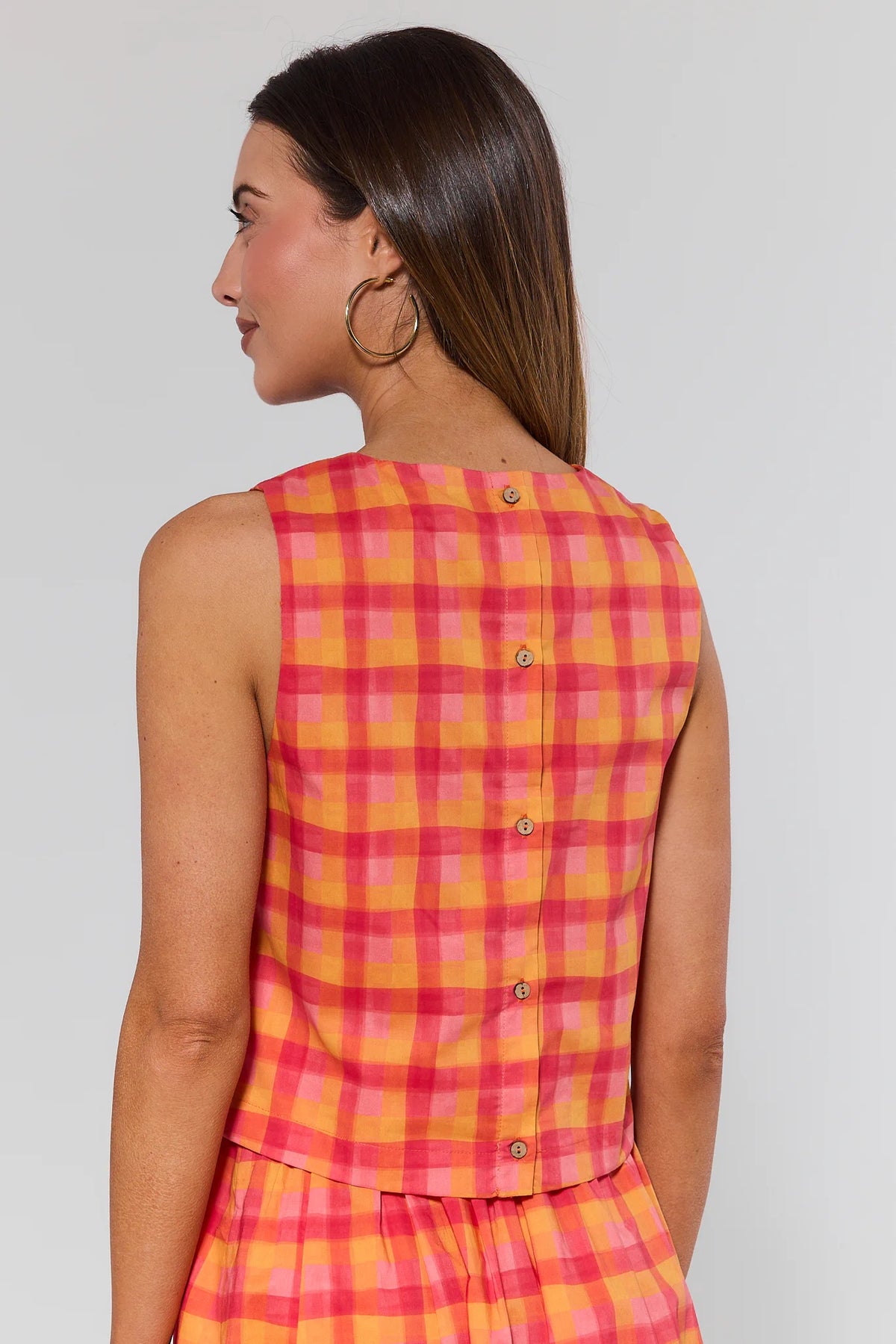 Orange pink plaid tank top back view showing button closure detail, styled with matching skirt | Avara