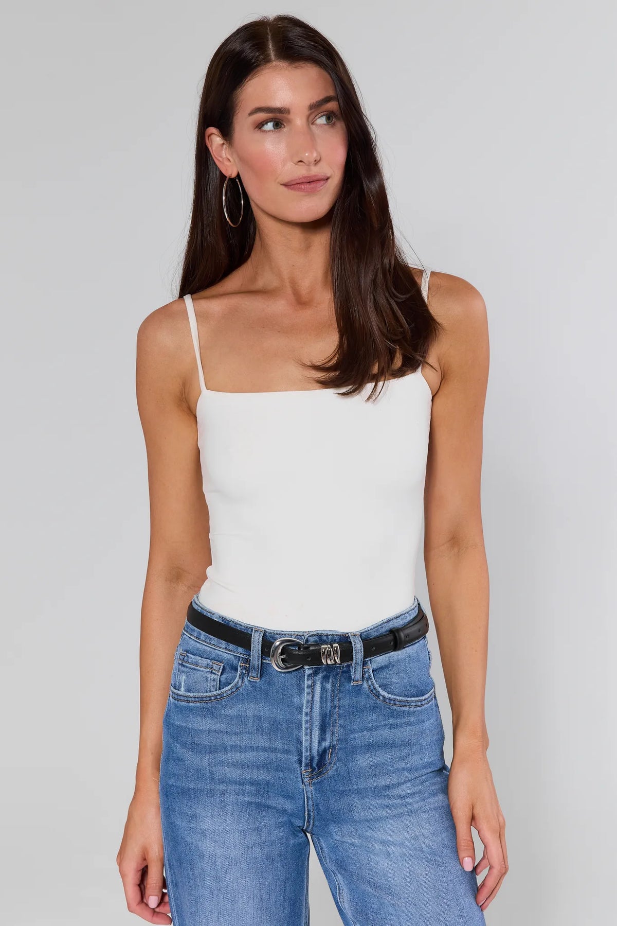 Caroline Black Keeper Belt styled on model with white cami and blue jeans, front view | Avara