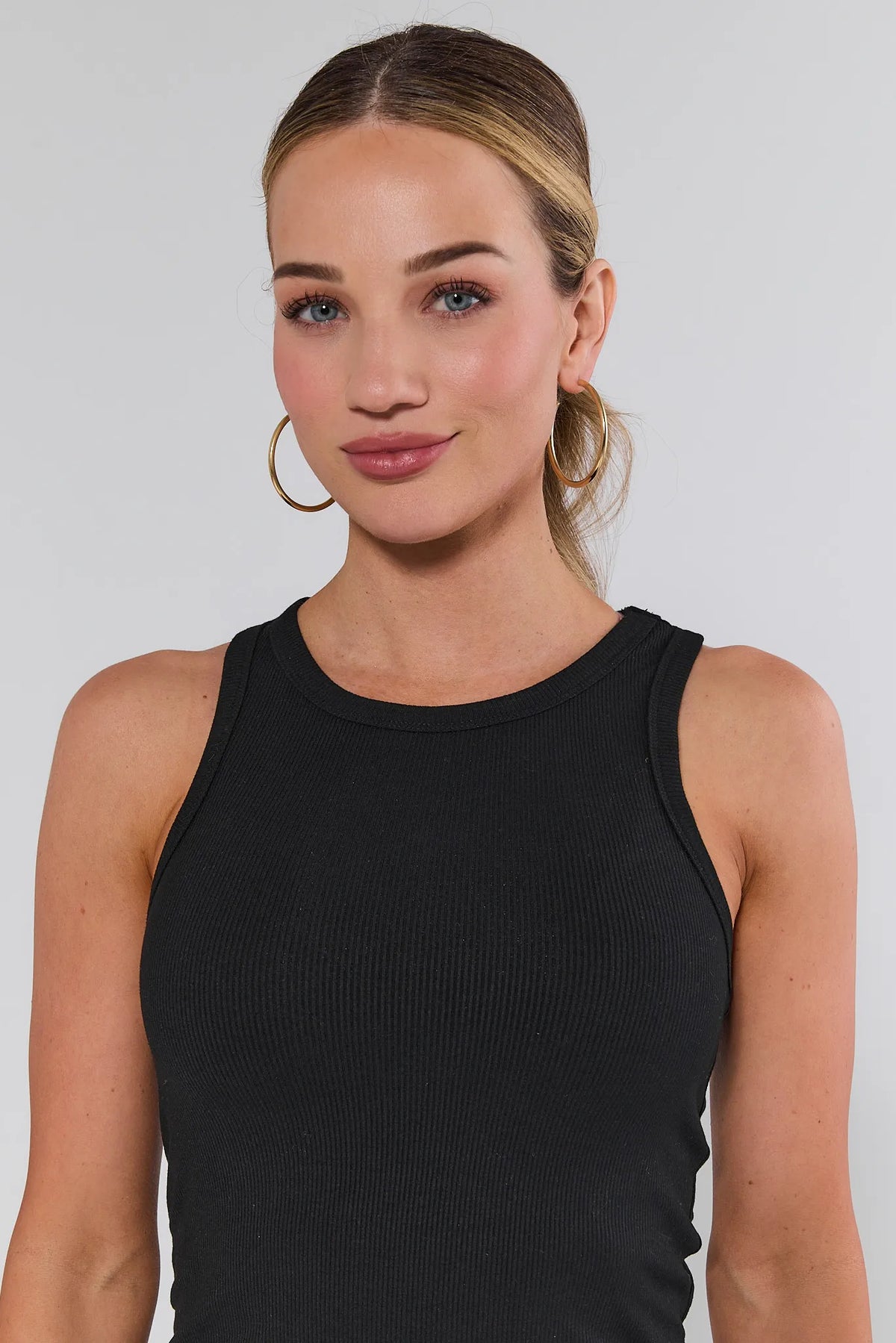 Allie black ribbed tank top women, close-up neckline detail on model | Avara