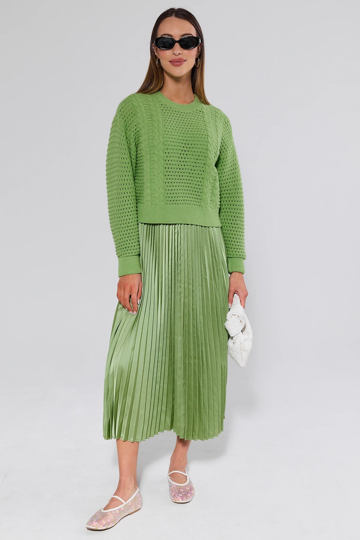 Green cable-knit sweater and pleated midi skirt two-piece set styled with sunglasses, full front view | Avara