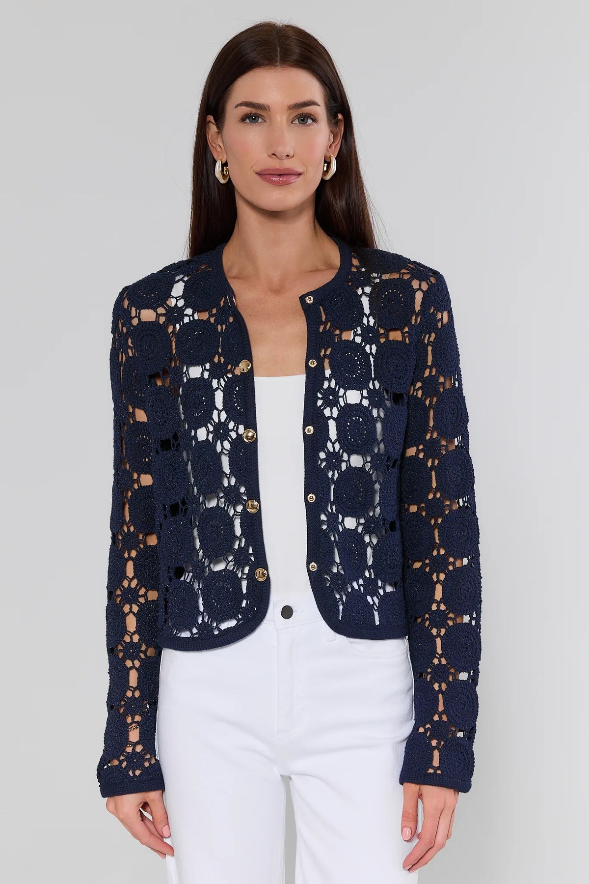 Cassidy Navy Crochet Cardigan with gold buttons over white top and pants - Front View | Avara